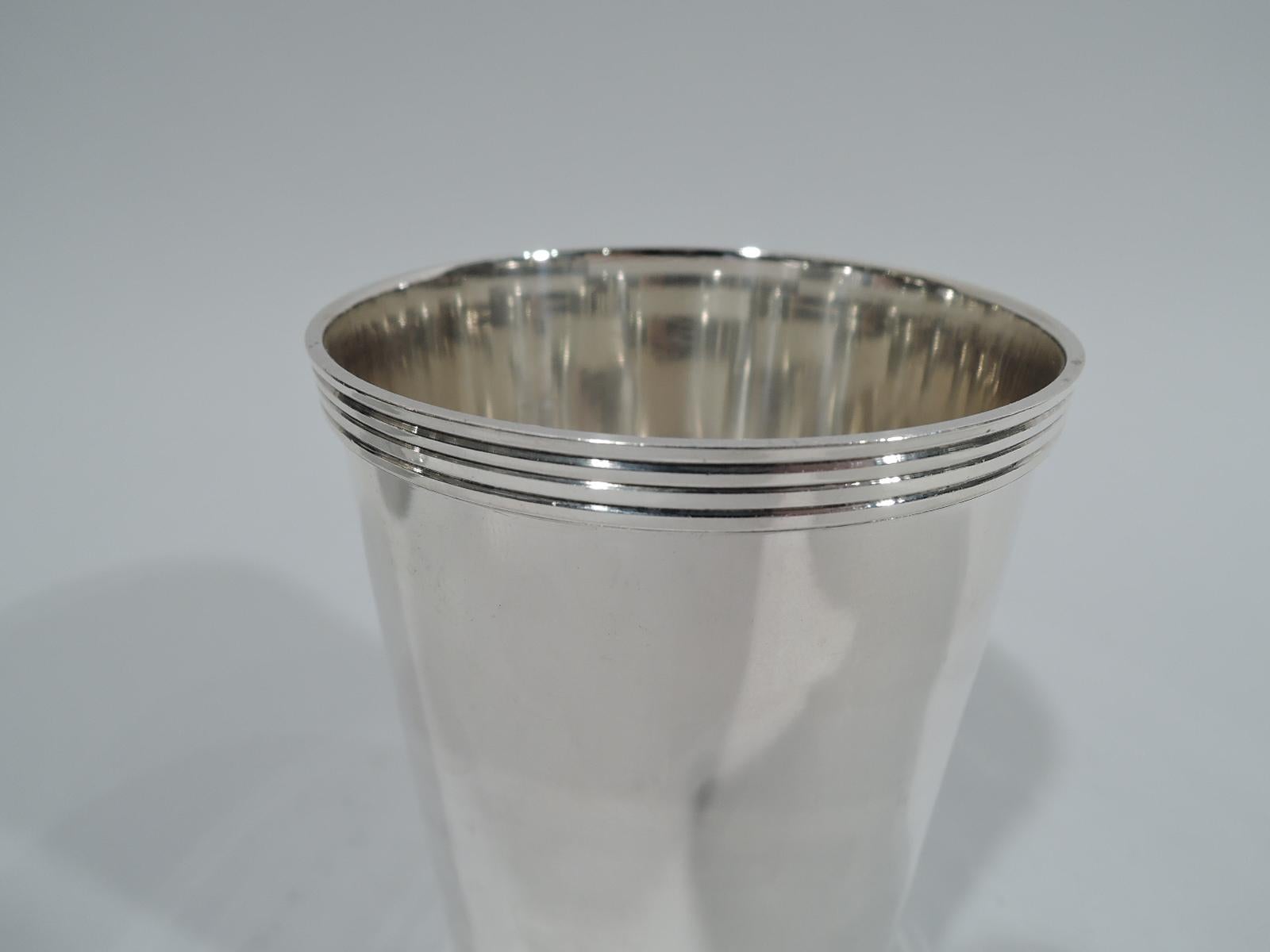Pair of traditional sterling silver mint julep cups. Made by Fisher in Jersey City. Each: Straight and tapering sides, and reeded rim and foot. Great for a booze-for-two night. Fully marked and numbered 50. Total weight: 7.5 troy ounces.