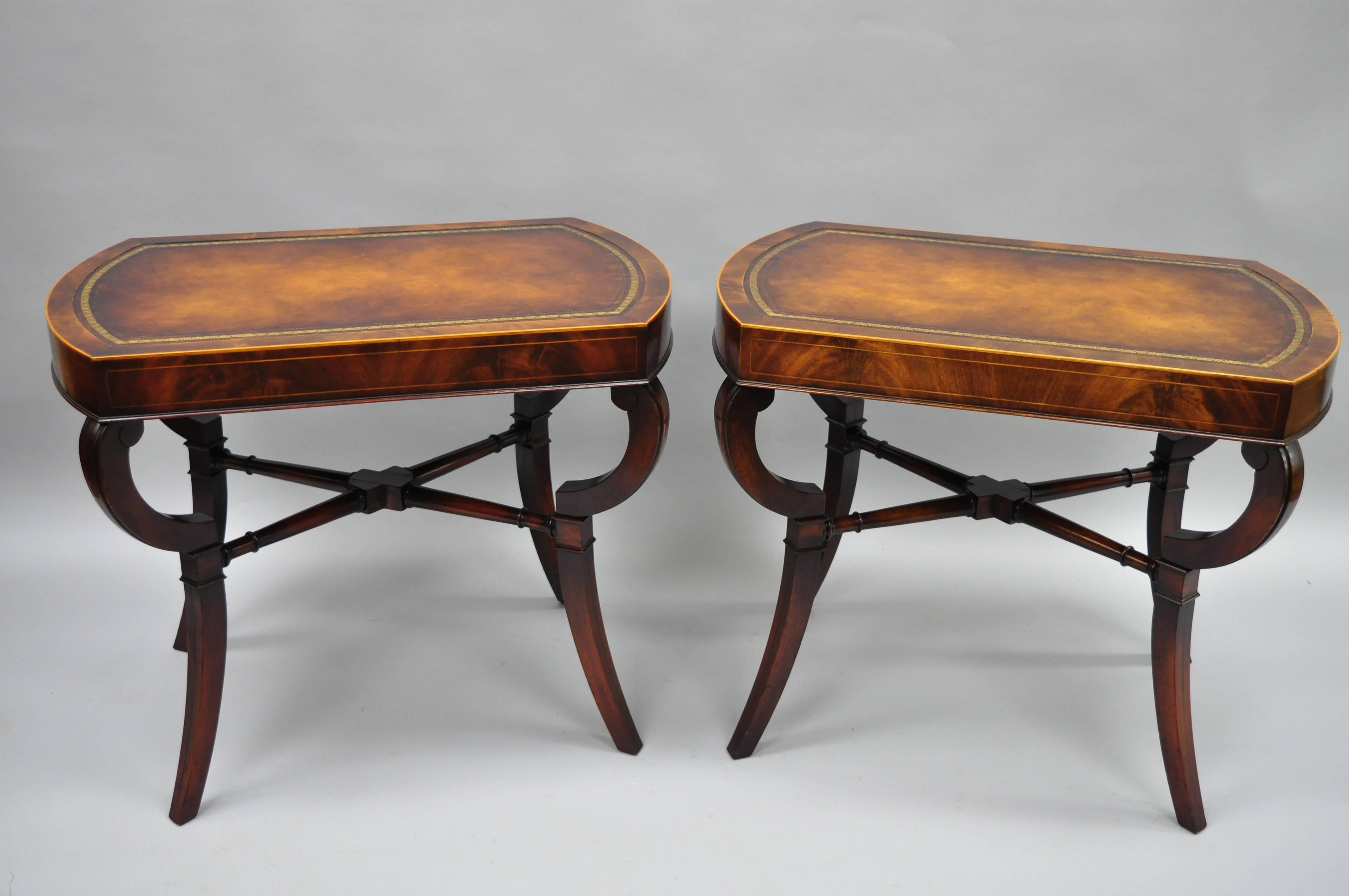 Pair of vintage flame mahogany leather top English Regency style side tables. Item features beautiful flame mahogany wood grain, leather top, shapely saber legs, nice pencil inlay and banding, quality craftsmanship, great style and form. Early to