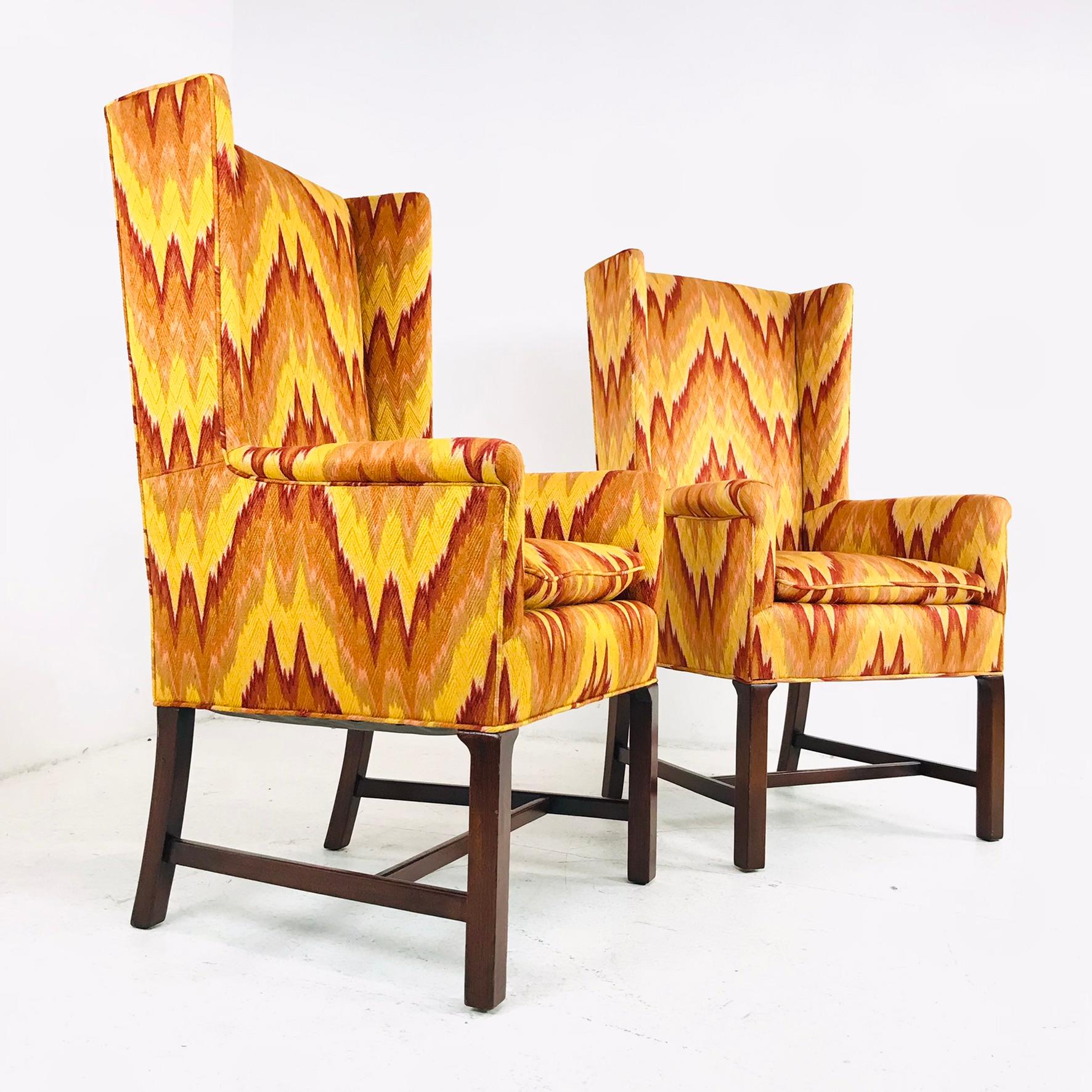 Amazing pair! These high back chairs are done in a bold orange and red flame stitch. Down filled seat cushions - upholstery is immaculate!