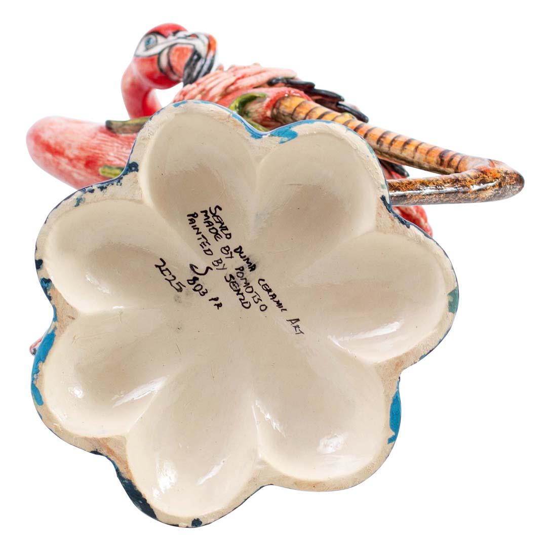 Esta exclusiva Pareja de Candelabros Flamencos y Flor de Lirio de Cerámica Senzo Duma es un testimonio del arte sudafricano, meticulosamente esculpido a mano por Phomotso Mafura y vibrantemente pintado a mano por Senzo Duma. Cada pieza, de