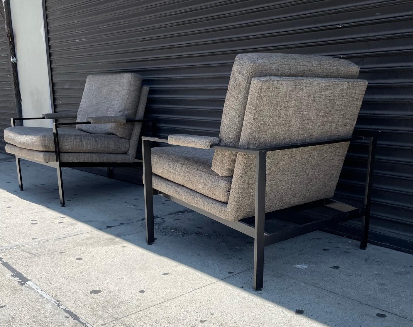 These beautiful lounge armchairs are by Milo Baughman for Thayer Coggin, designed in 1966, and produced by Thayer Coggin in High Point, North Carolina, made in the USA. 

The flat bar metal frames have a black finish and the seats are upholstered
