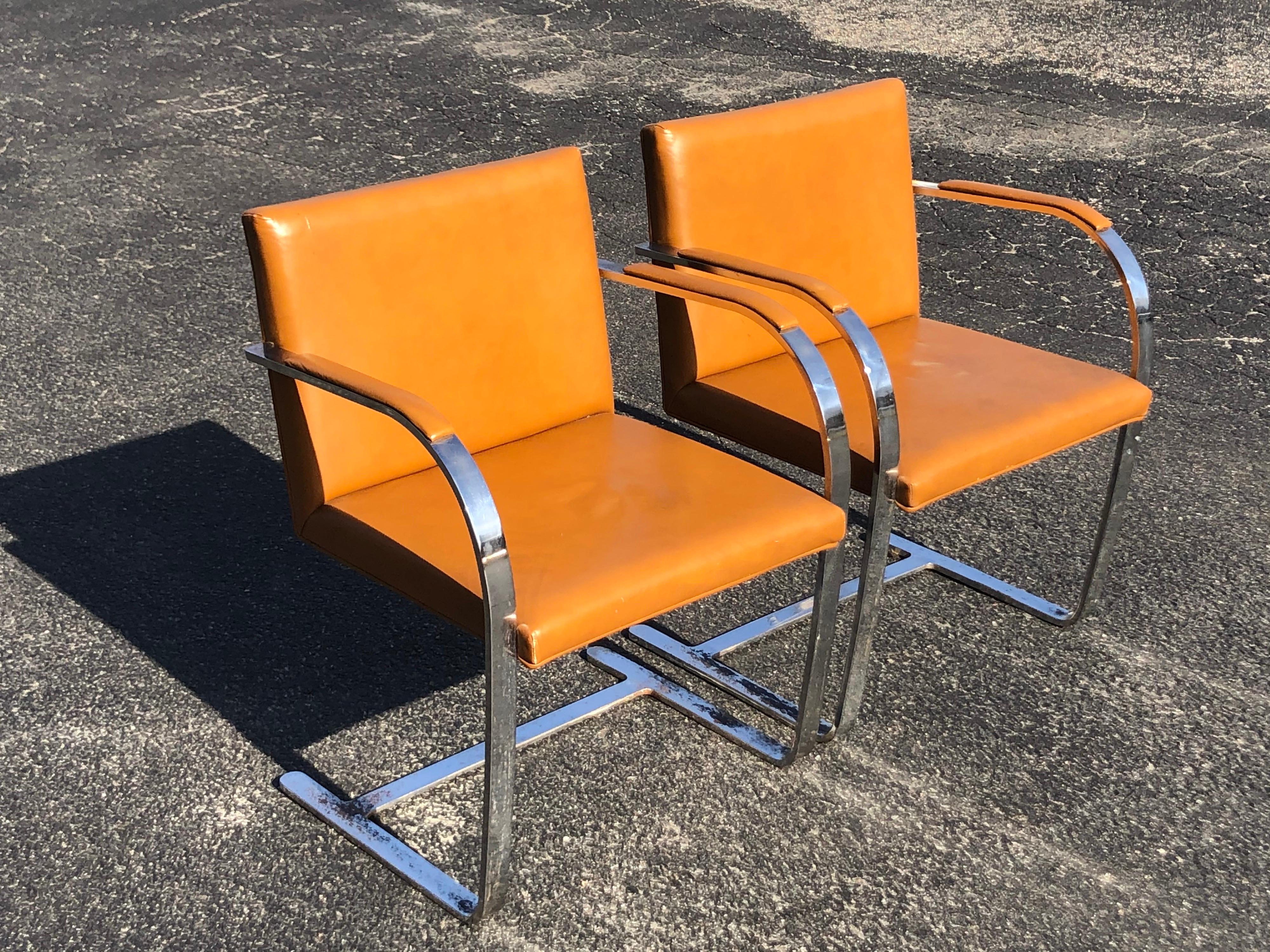 Pair of Flat Bar Brno chairs in the Style of Mies Van Der Rohe. Classic Knoll style Chrome cantilever chairs In caramel colored leather. No labels found but heavy chairs.