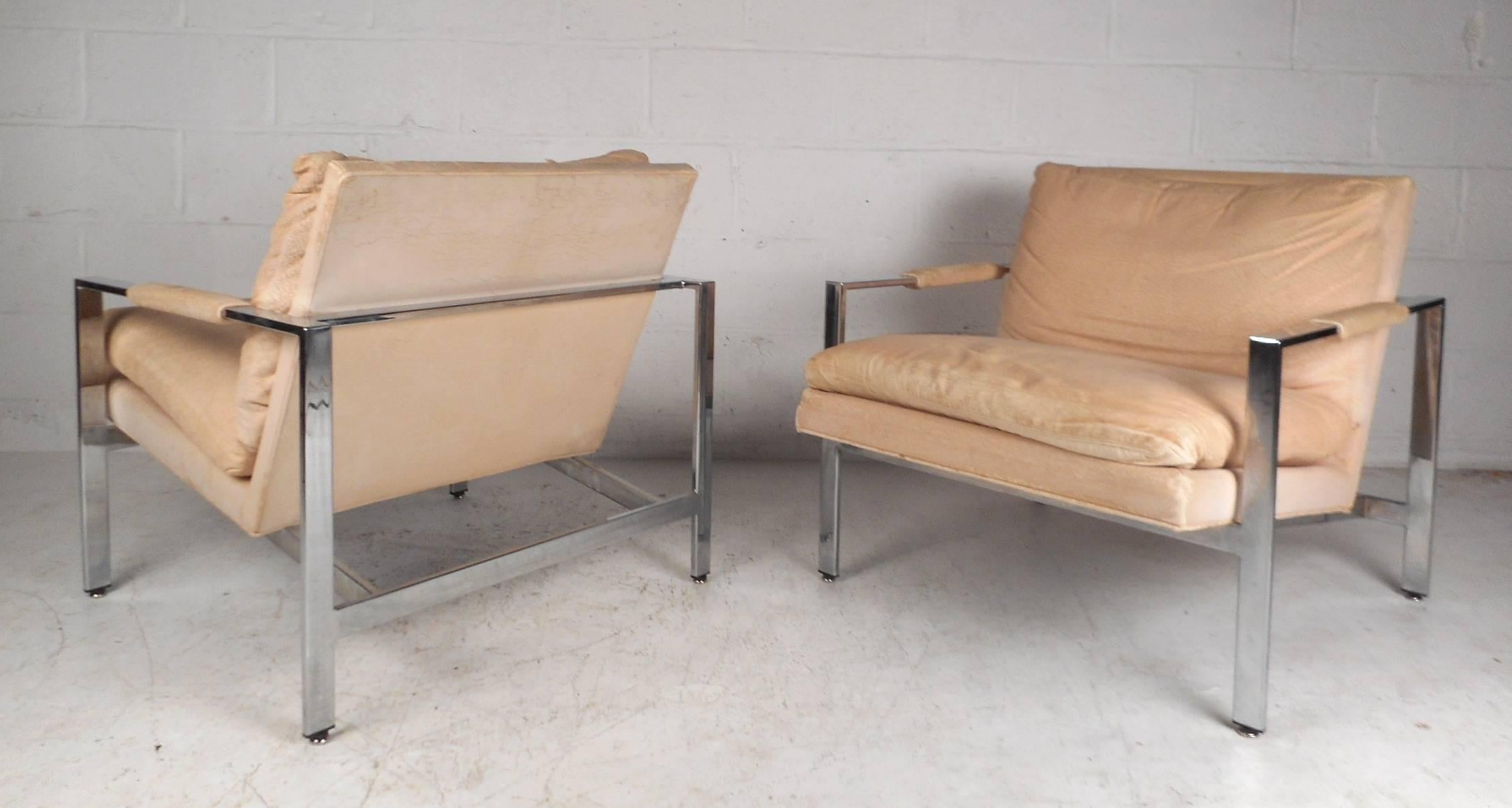 This fabulous pair of vintage modern armchairs feature a heavy flat bar chrome frame with a thick padded removable seat cushion. The wide seats, angled back rest, and stylish low arm rests ensure maximum comfort within any seating arrangement.