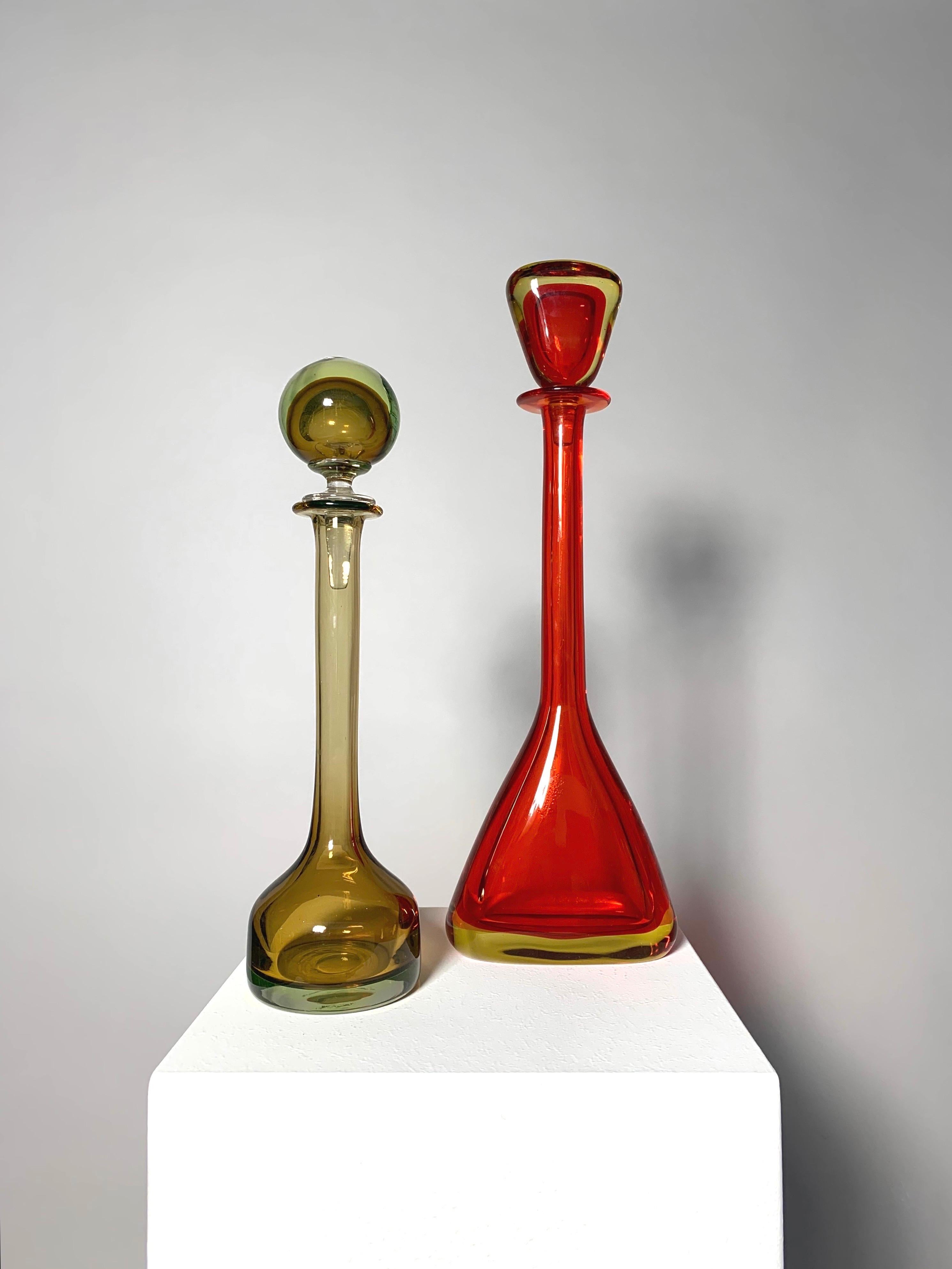 Rare pair of large Flavio Poli bottles for Seguso Vetri d‘Arte, designed around 1962-1963, mouth-blown and hand-shaped in Sommerso glass.

Red bottle is 46 cm tall
Yellow-brown bottle is 39 cm tall.