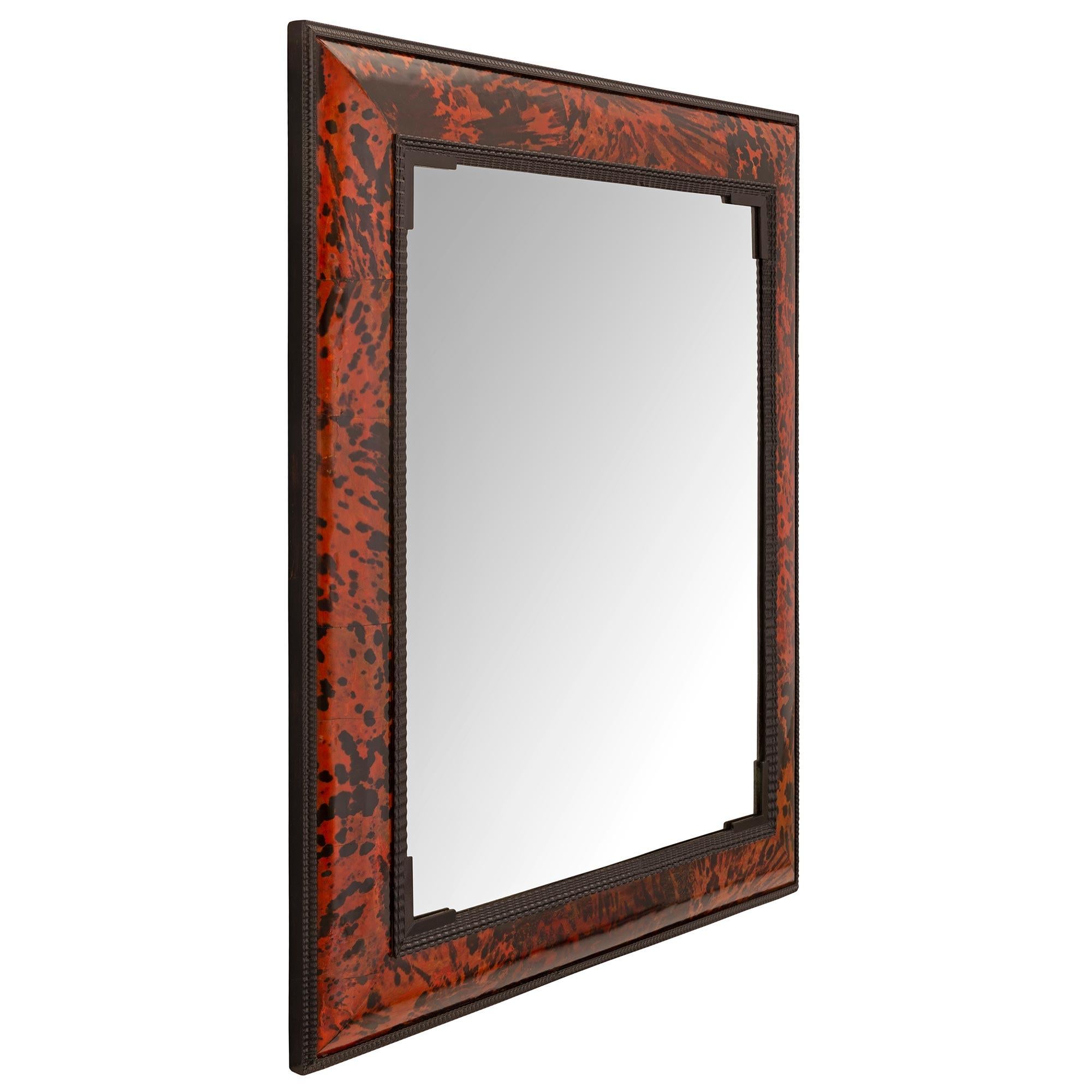 A stunning pair of Flemish early 19th century Baroque st. Tortoiseshell mirrors. Each mirror retains its original beveled mirror plates set within a beautiful unique wave like design and striking red Tortoiseshell frame. These mirrors can be