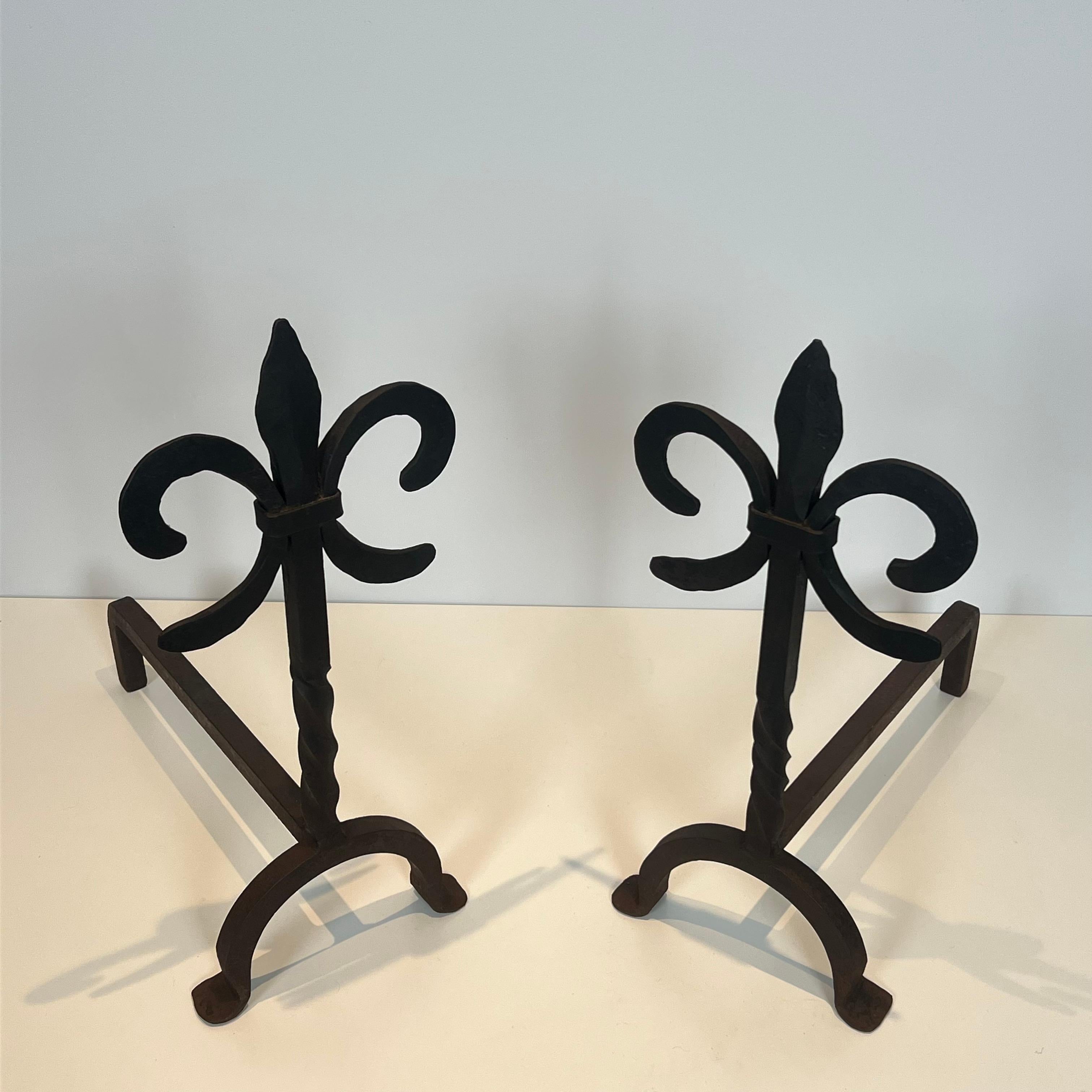 This nice pair of fleurs de lys andirons is made of wrought iron.This is a French work. Circa 1940
