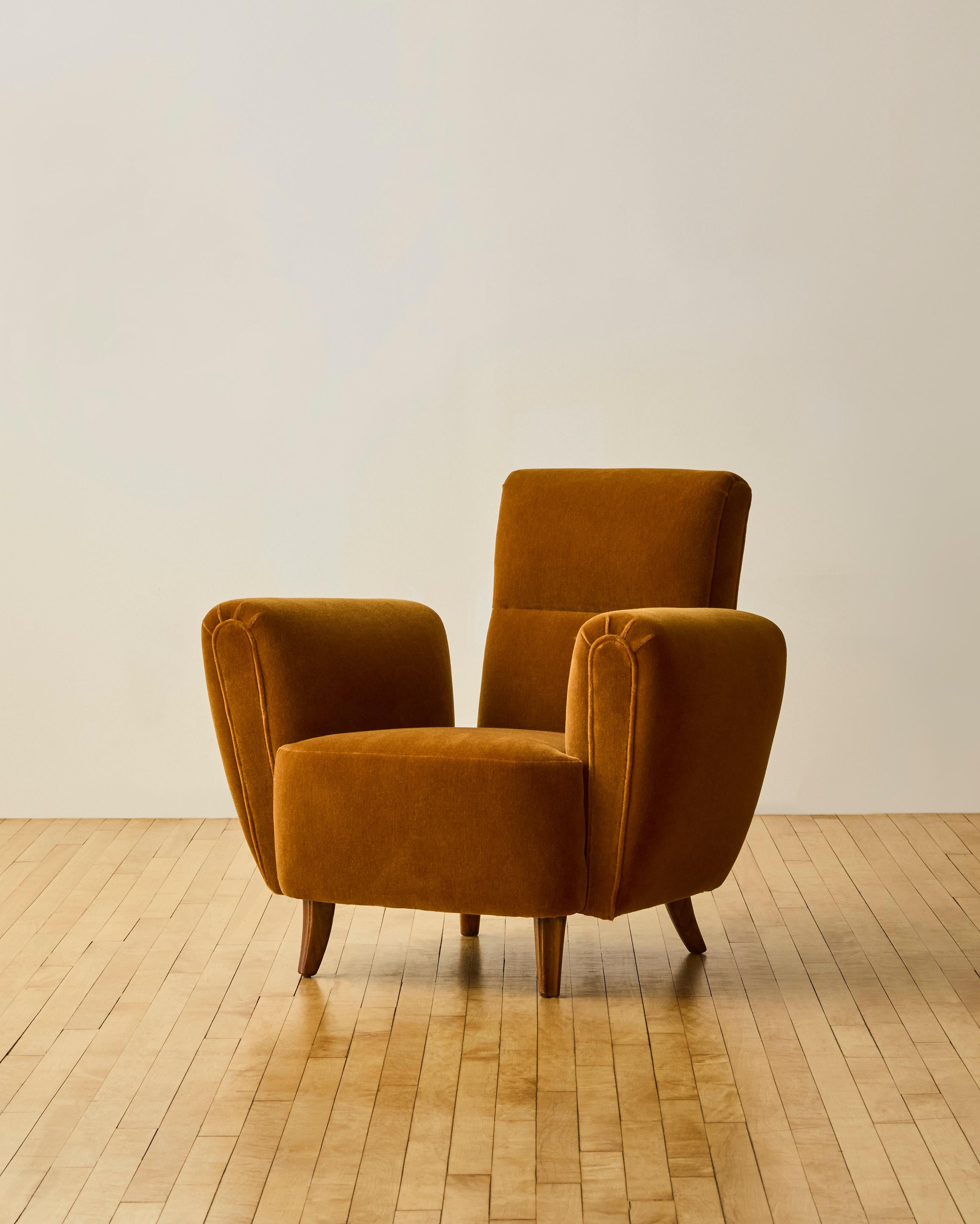 Pair of floating arm deco lounge chairs C. 1940's newly reupholstered in soft wool burnt ochre mohair.