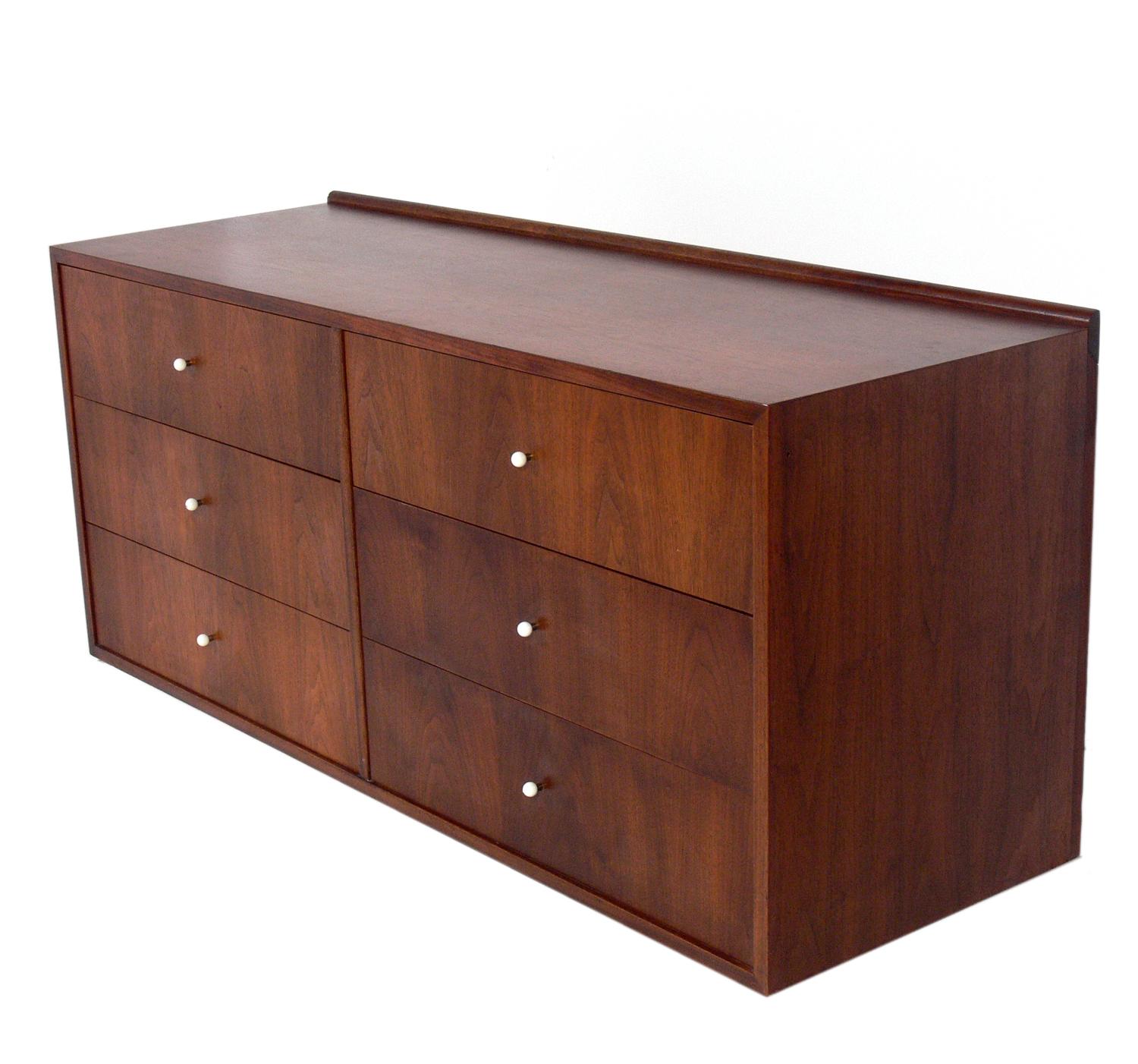 Pair of floating chests or nightstands, designed by Kipp Stewart for Drexel, American, circa 1960s. These are a versatile size and can be used as chests or dressers, or as large scale night stands. They have a sturdy cleated wall mounted bracket