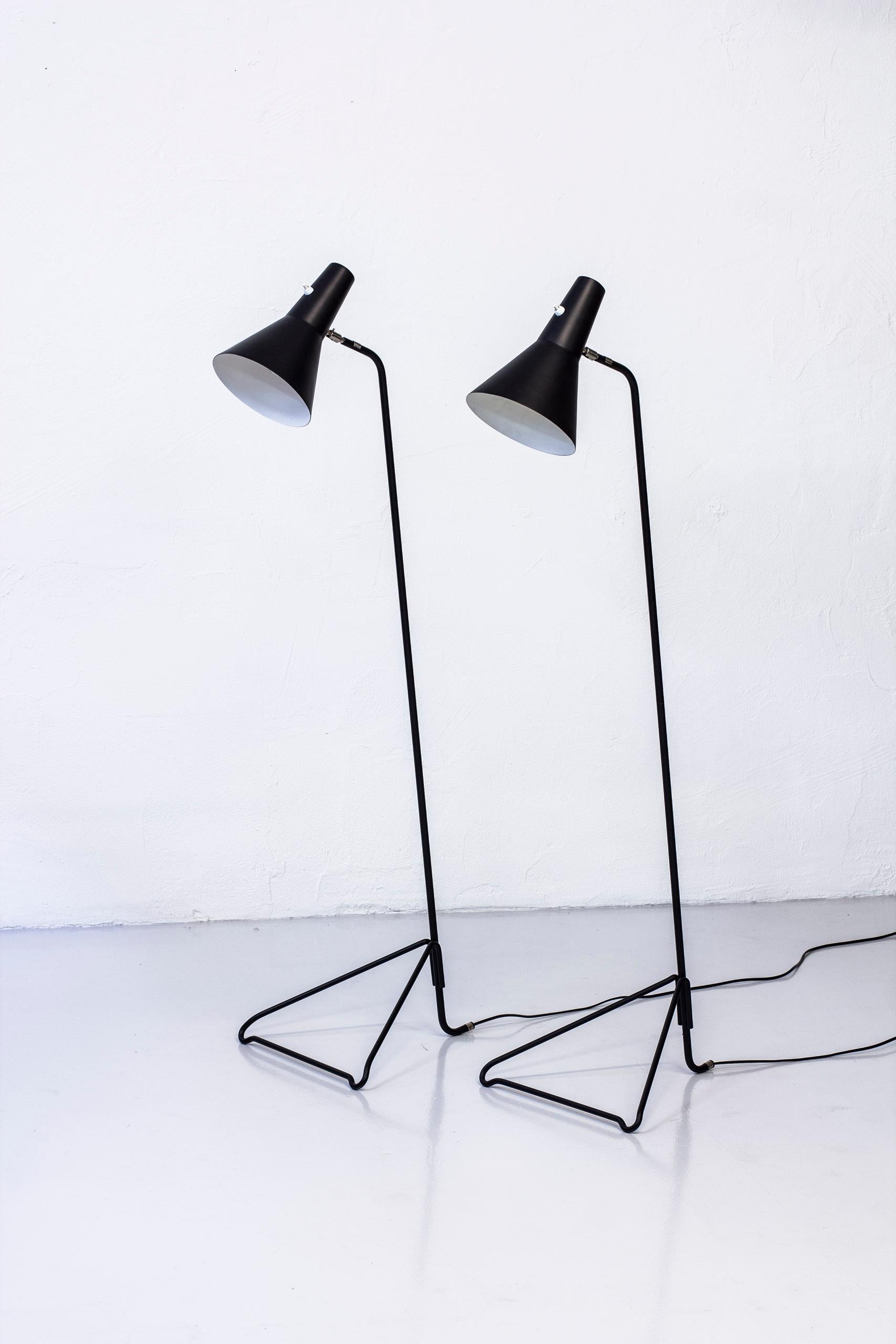 Floor lamp produced during the 1950s in Sweden by ASEA. Black lacquered metal base and shade with chromed details. Adjustable angle on the shade. Light switch on top of the lampshade in working condition. Signed with ASEA hallmark on the shade. Very