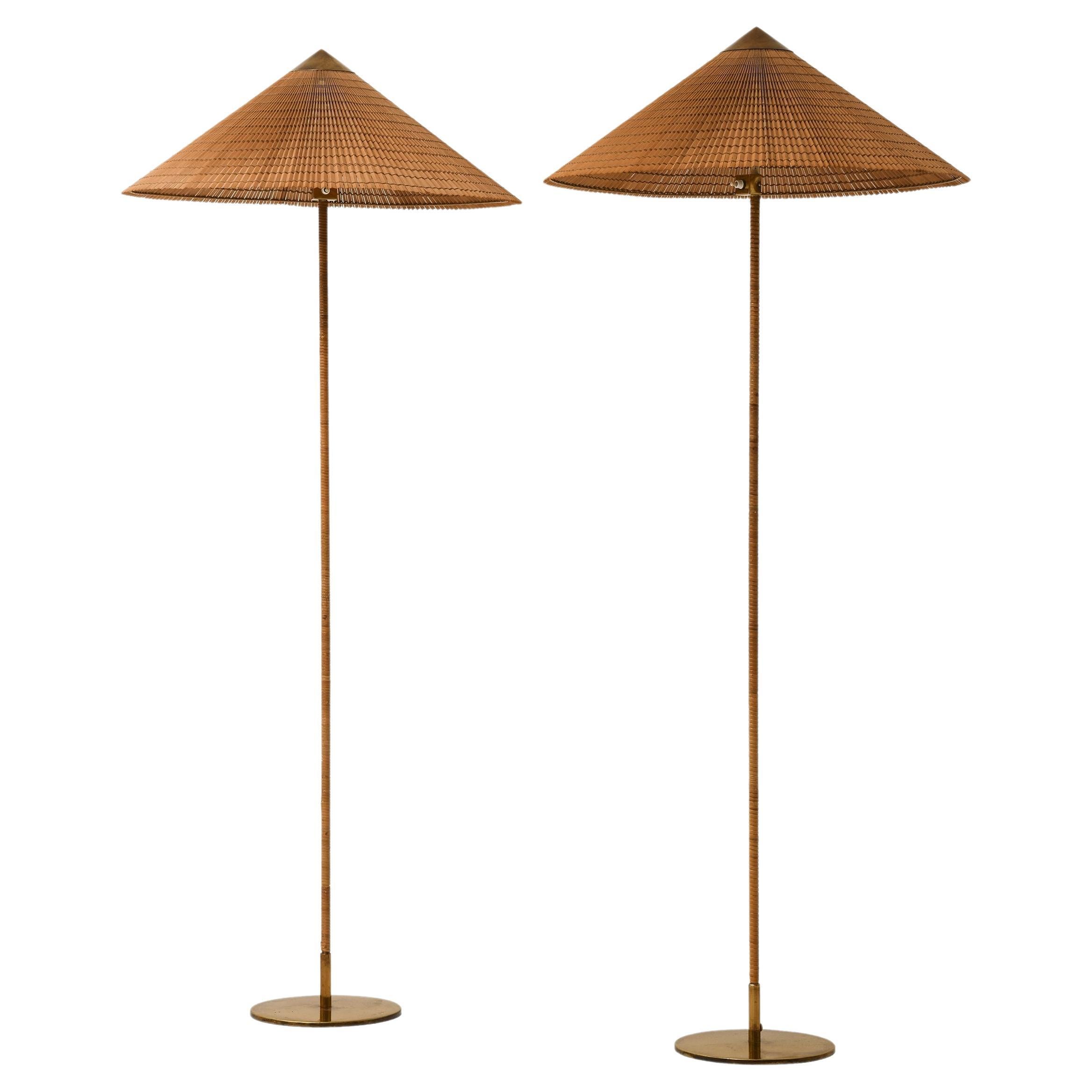 Pair of Floor Lamps in Brass, Cane and Cane Shades by Paavo Tynell, 1950's