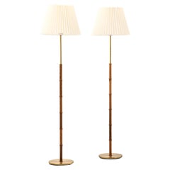 Paire de lampadaires en palissandre et laiton, années 1950