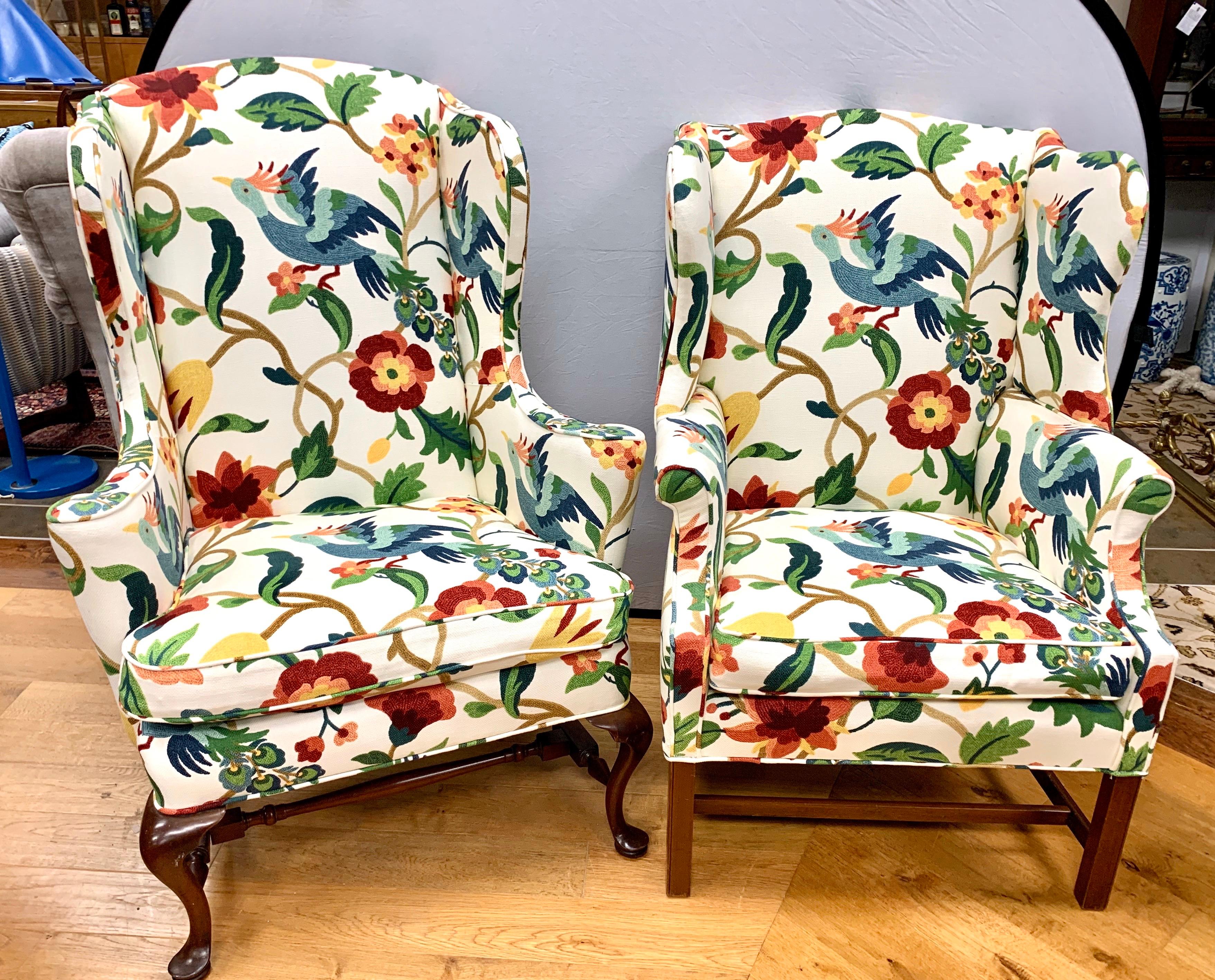 His and hers wingback chairs upholstered in fabric reminiscent of a crewelwork textile with its bright colors and floral and bird motif. The fabric is nothing short of magnificent.