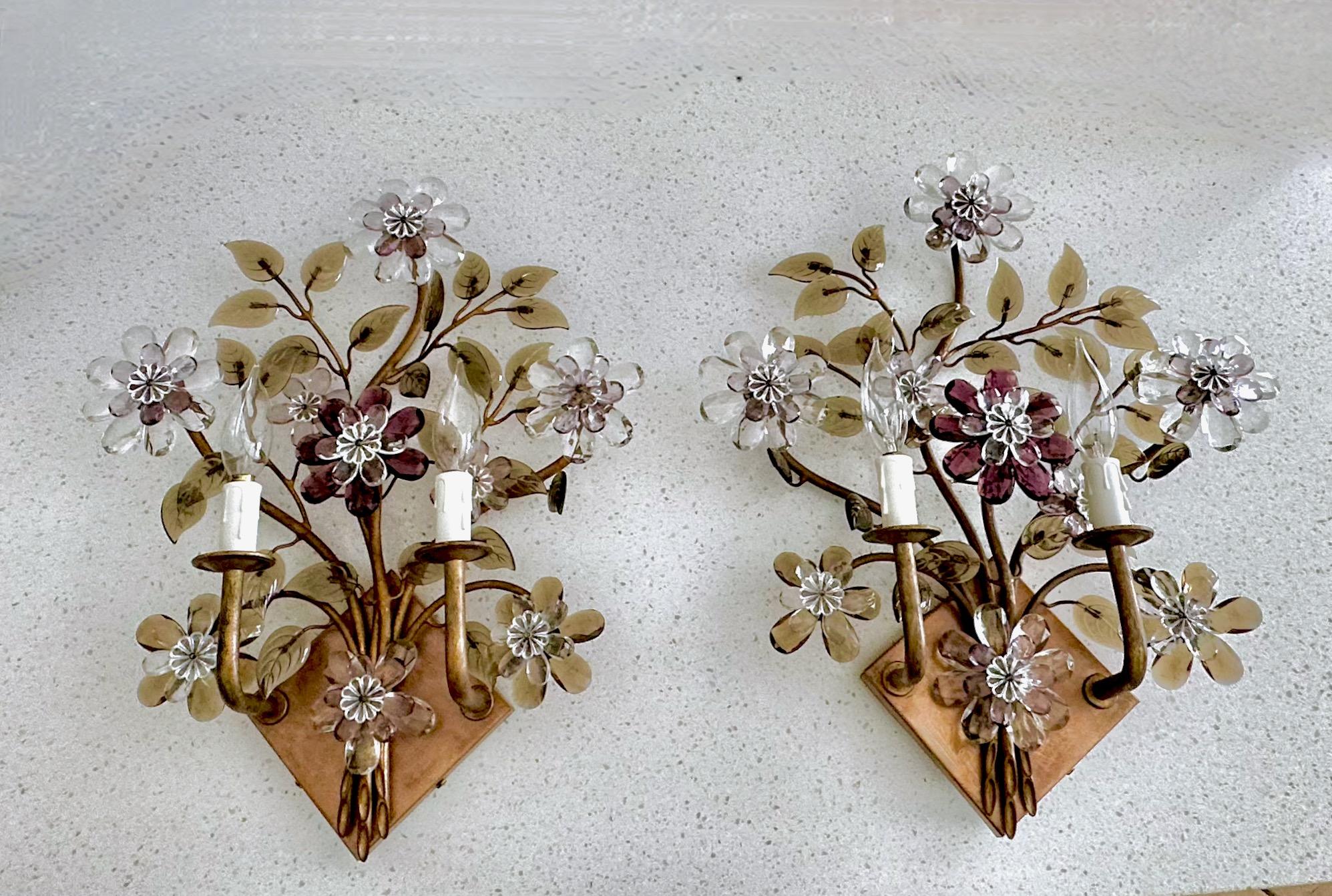 Pair two-light wall sconces designed by Oswald Haerdtl for J.L Lobmeyr. The patinated brass structure is welded to create the delicate organic branches. These are decorated with clear, purple and smoked crystals creating a bouquet of blossoms and