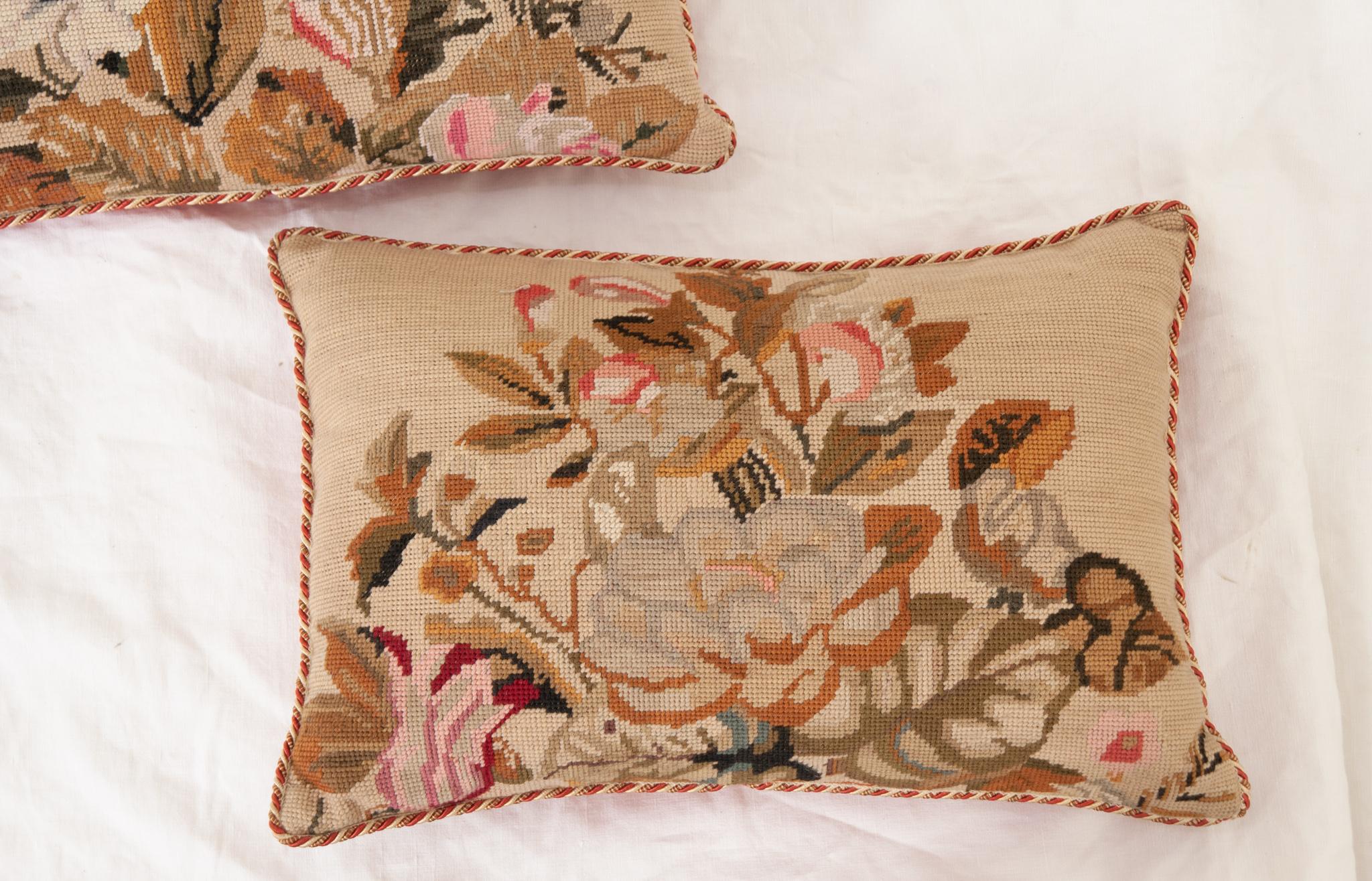 A vintage pair of needlepoint pillows are in great shape. All handmade with flowers and braided trim. The pillow cases have inset zippers and the pillow insert can be removed. Be sure to view the detailed images. 
