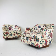 Pair of Floral Swivel Chairs in the Style of Milo Baughman.