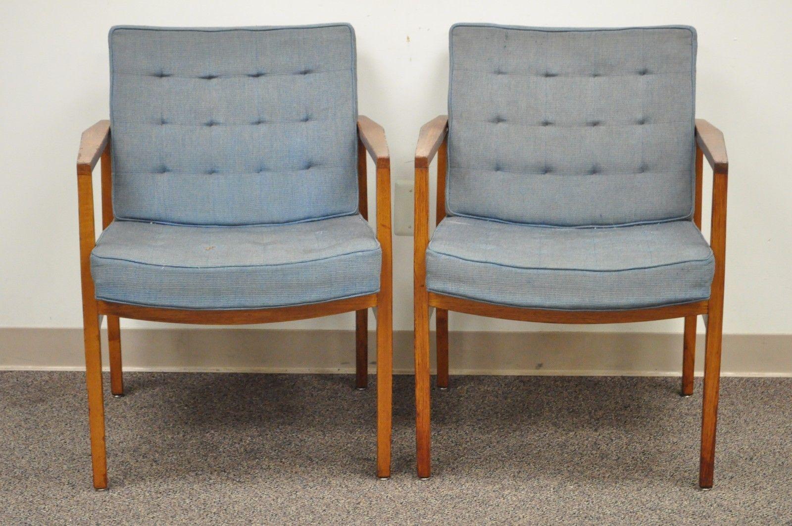 Pair of Early Knoll International armchairs. Made in Belgium. Design attributed to Florence Knoll. Item features clean modernist lines, heavy solid wood frames (Believed to be Walnut), and retains original label which reads 