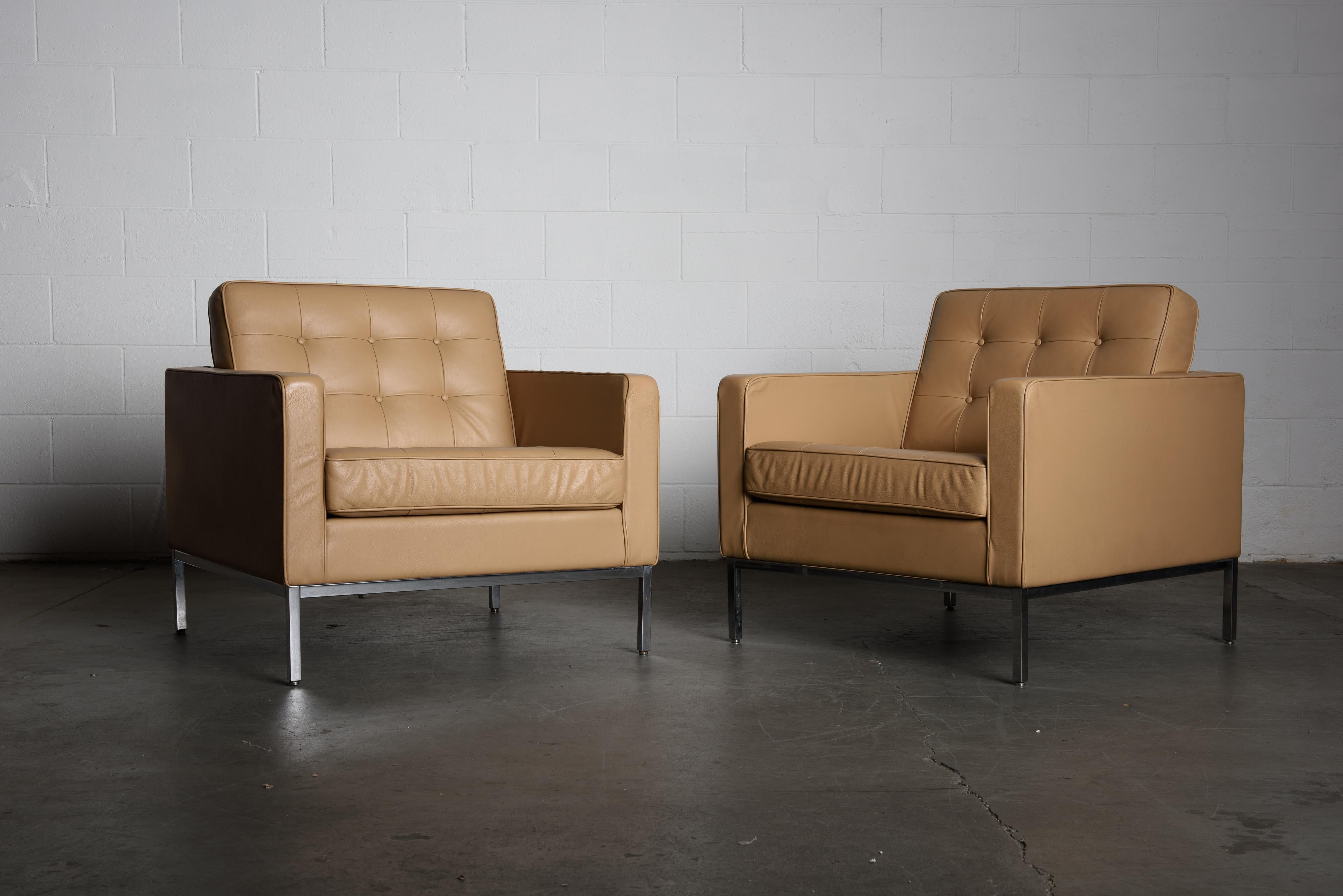 This pair of Florence Knoll leather lounge chairs for Knoll Studio feature soft supple leather over a chrome base, with a Knoll Studio embossed stamp and Florence Knoll's signature embossed on one leg of each chair, and Knoll repeat fabric on the