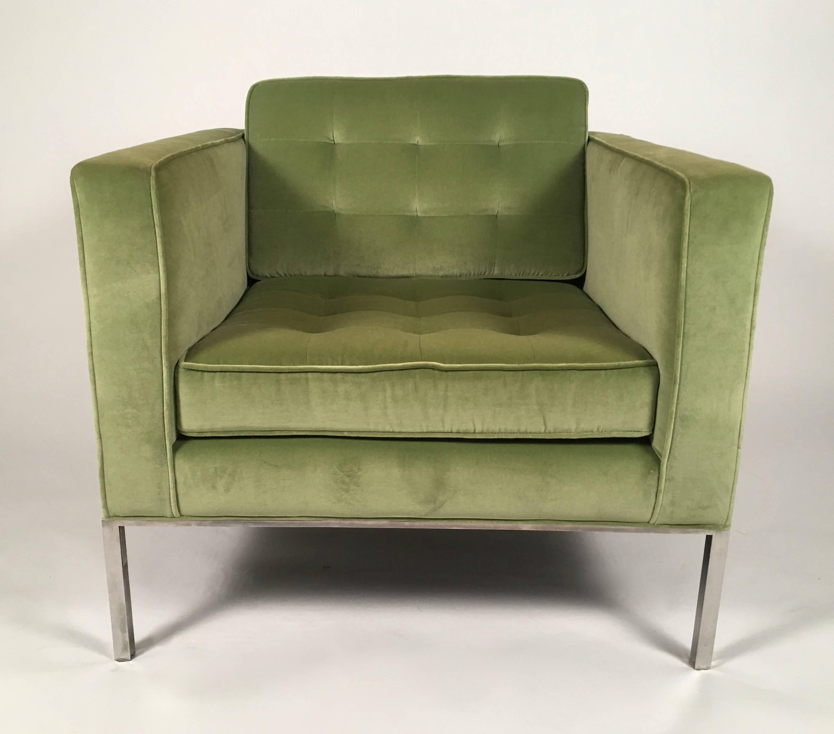 An original pair of Florence Knoll lounge chairs, designed in 1954, of square form, with loose tufted back and seat cushions, raised on exposed metal frame and legs in heavy gauge steel with polished chrome finish. Upholstered in high quality moss