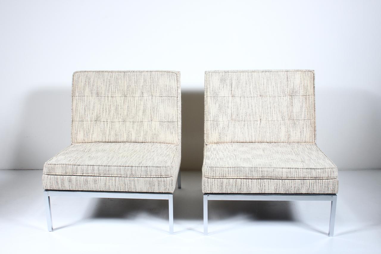 Classic pair of florence Knoll chromed steel and Earthen Fabric Lounge chairs. Featuring 1 inch reflective sturdy, solid Chromed Steel constructed framework, angled rear legs and back, with original tufted, neutral Off White and Brown woven Knoll