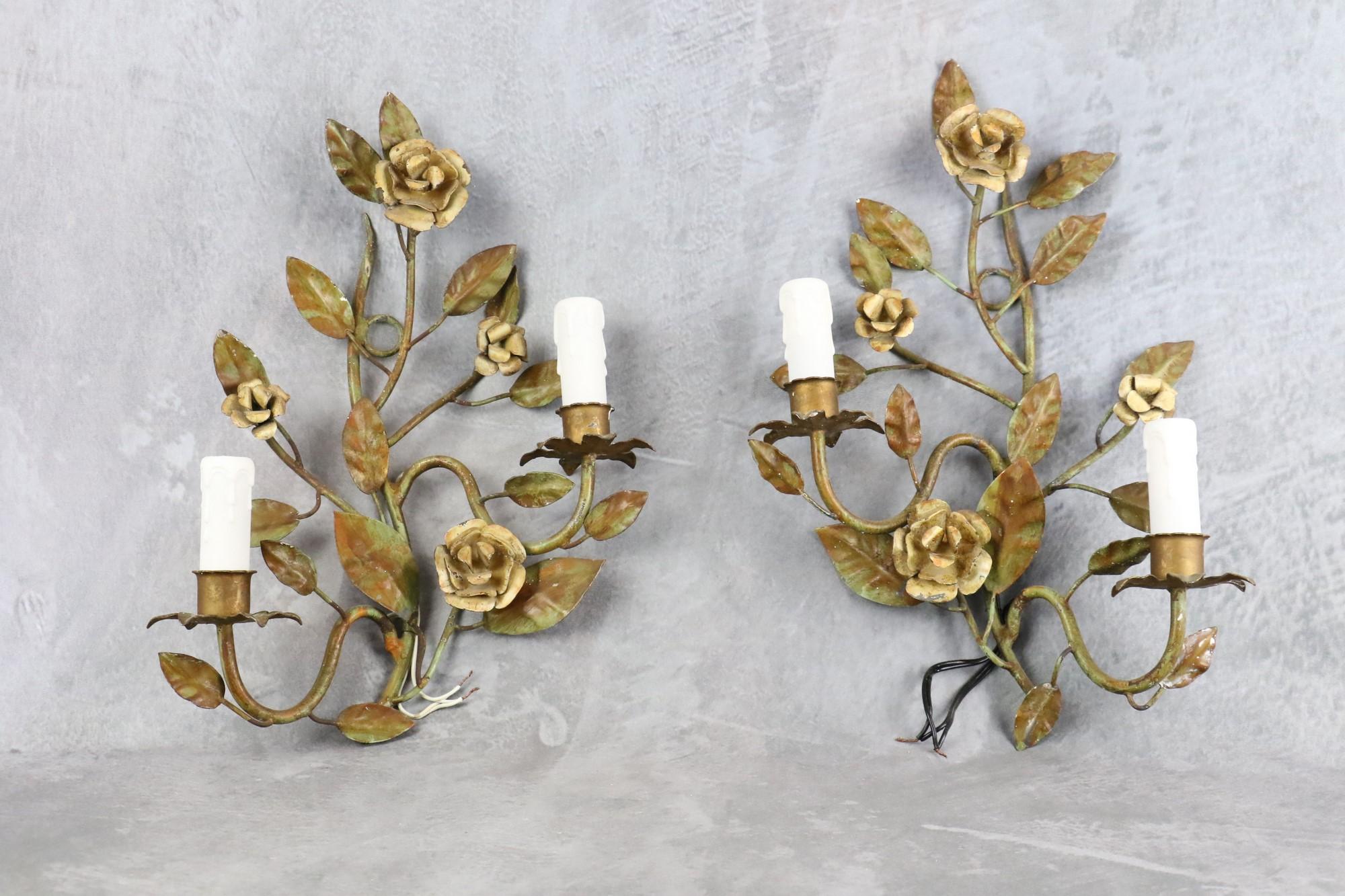 Pair of Florentine sconces decorated with foliage and roses, 1960, Italy

Beautiful pair of sconces in patinated metal, decorated with leaves and roses. The lights are imitation candles. 
Very decorative, they are large without being too imposing.