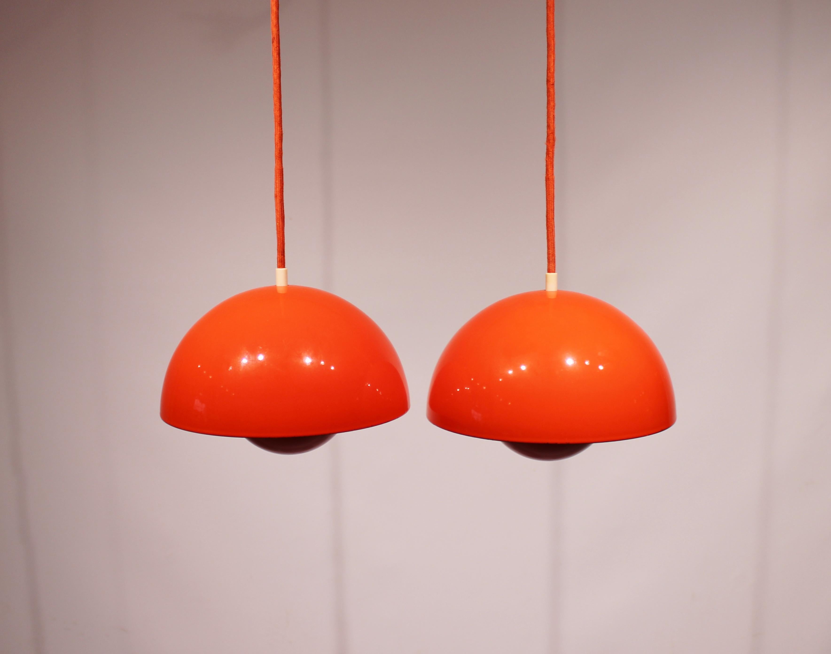 A pair of flowerpot, model VP1, pendants in orange designed by Verner Panton in 1968 and manufactured in the 1970s. The lamps are in great vintage condition.