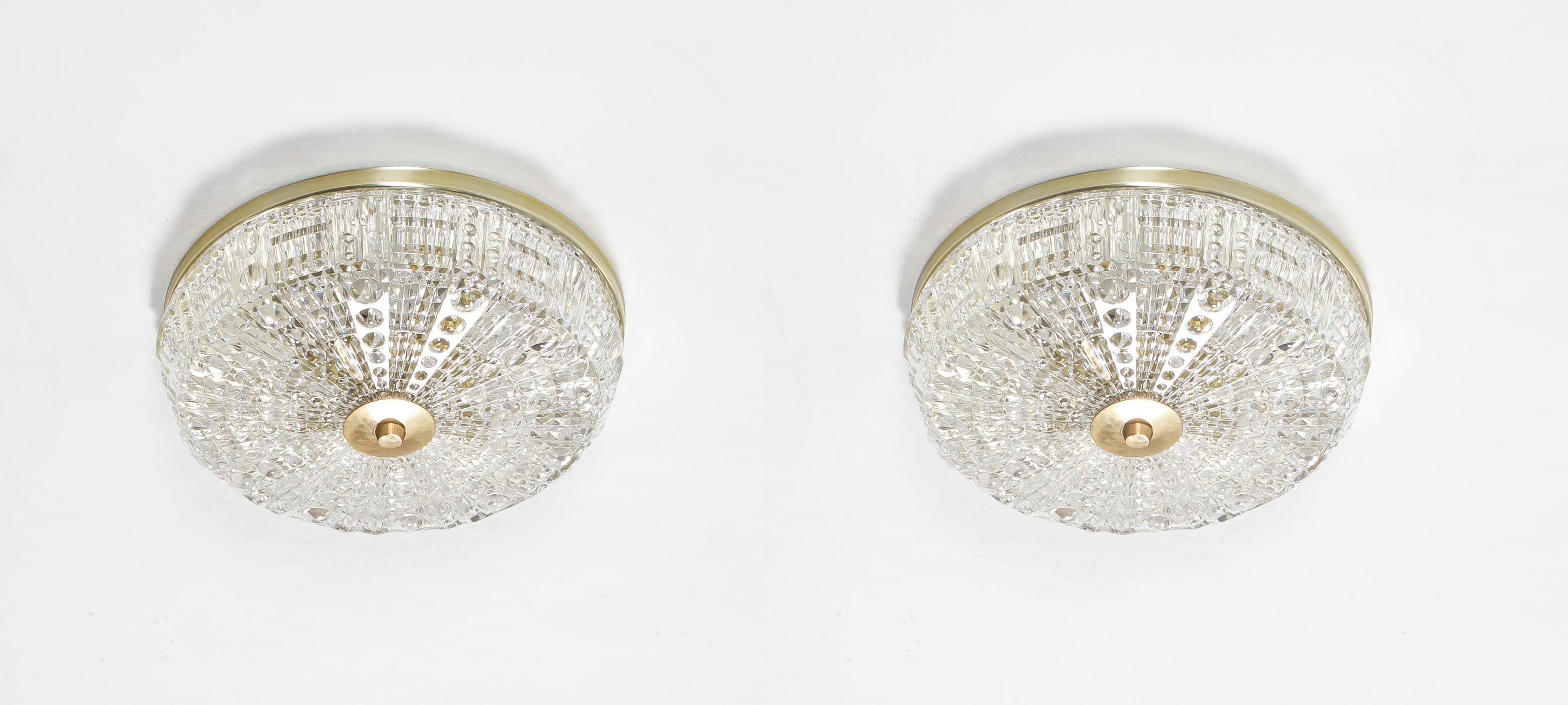 Wonderful and decorative flush mount ceiling lamps in crystal glass and base in brass. Designed by Carl Fagerlund and made by Orrefors from circa 1970s second half. Both lights are working and in very good vintage condition. They are each fitted