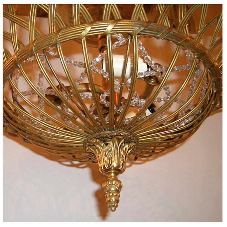 A pair of circa 1920's French light fixtures with gilt bronze body in a woven basket design with beaded crystal insets and interior lights. Sold individually.

Measurements:
Height: 10″
Diameter: 16″