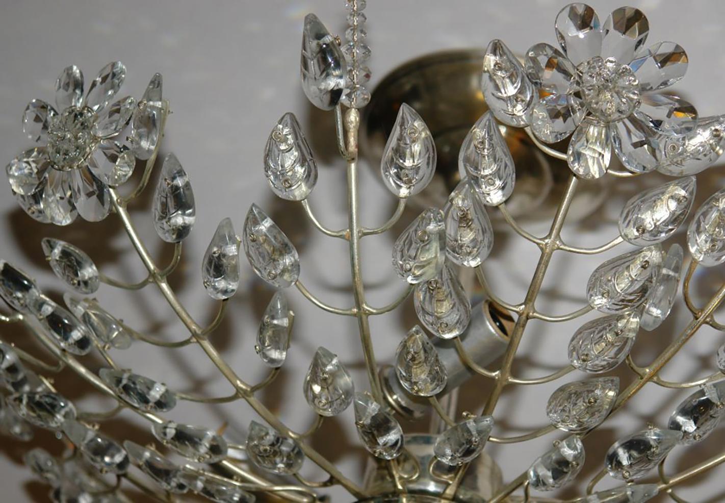 Pair of circa 1940’s French silver plated light fixtures with molded glass leaves and crystal flowers, mercury glass body and 3 interior lights. Sold individually.

Measurements:
Diameter: 18″
Current drop: 9.5″ 