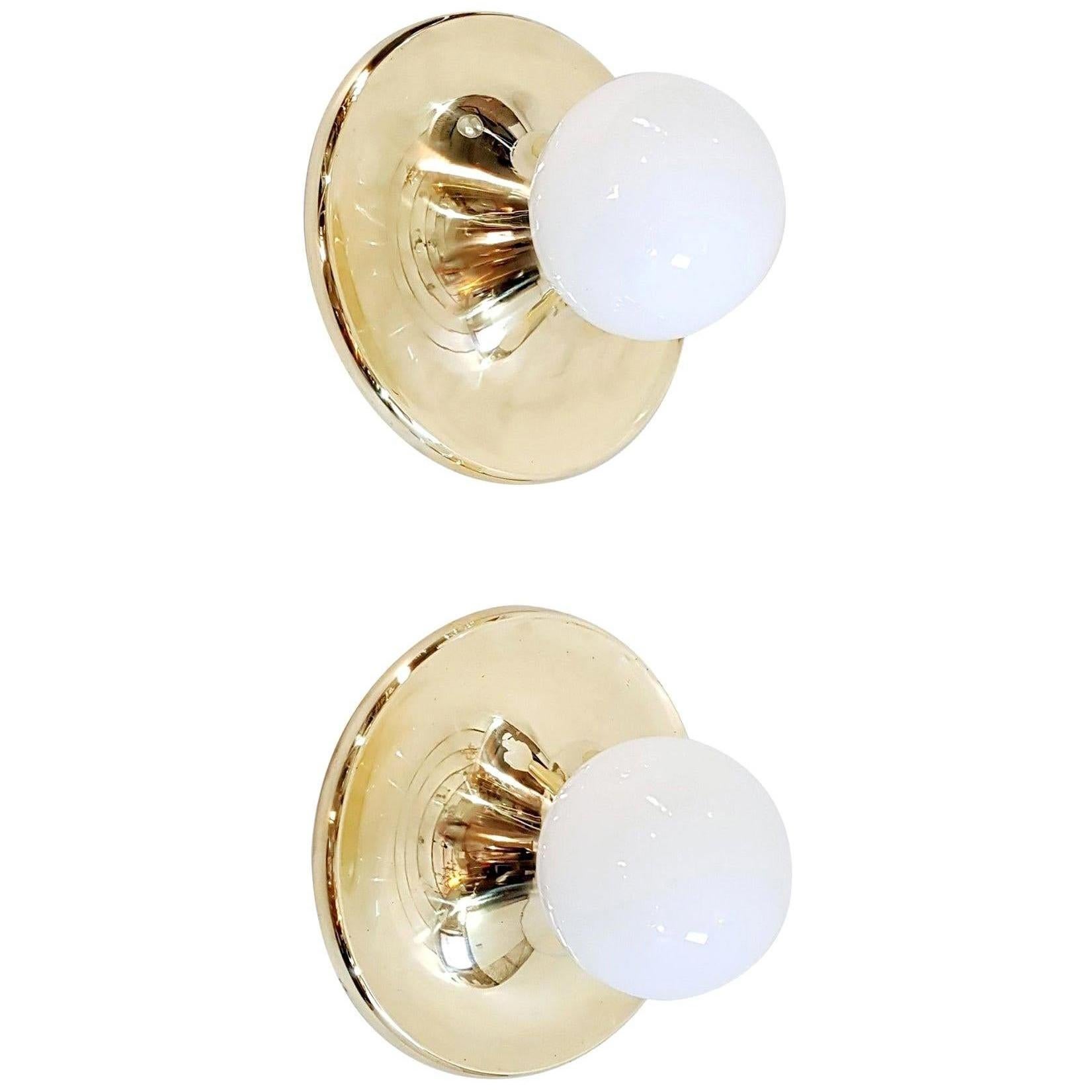 A large pair of lamps that can be used as flushmounts or wall sconces by Achille & Pier Giacomo Castiglioni for Flos. Designed and manufactured in Italy, 1965. Brass and opaline glass. Each light takes one E27 bulb. The brass has been professionally