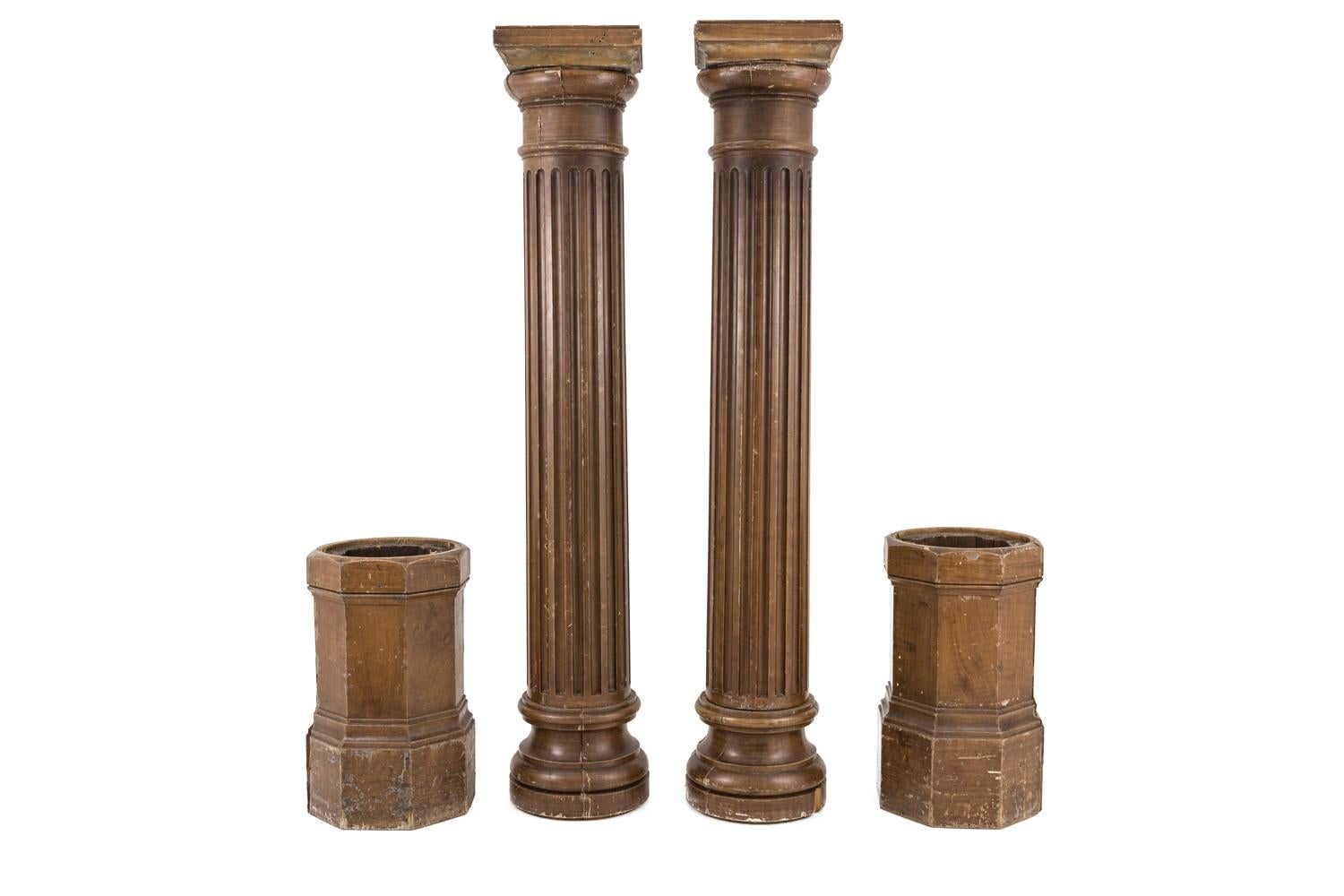 Pair of large fluted columns in brown lacquered wood with a small capital. They stand on octagonal molded movable bases.

Work realized at the end of the 19th century.

Important use marks due to use and time.

Dimensions: H 283 x D 42 cm