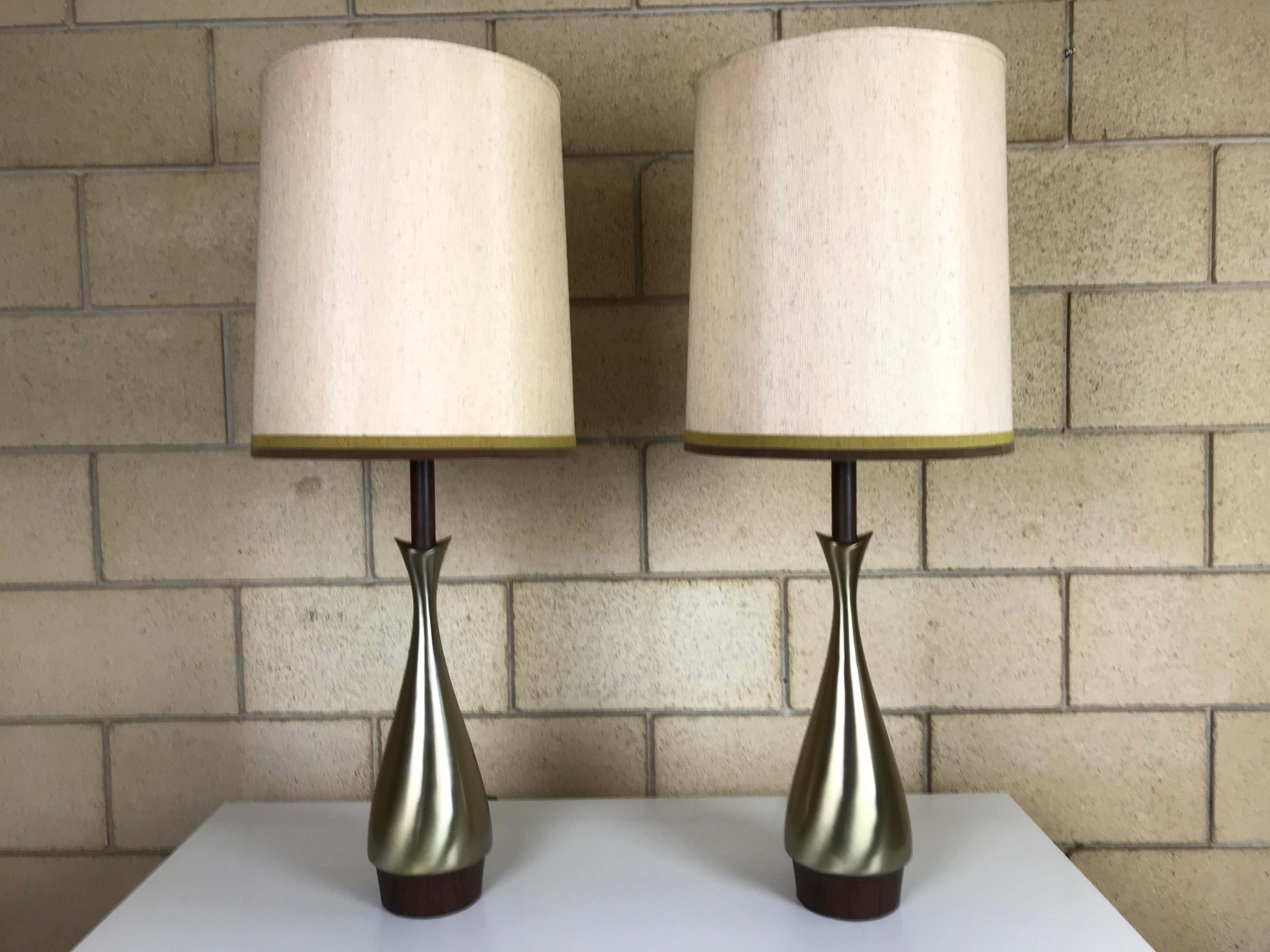 A pair of wonderfully designed brass and rosewood laminate three-stage table lamps by the Laurel Lamp Co. These lamps are in great condition and have their rare original shades that are signed.
Lamp base measures: 34