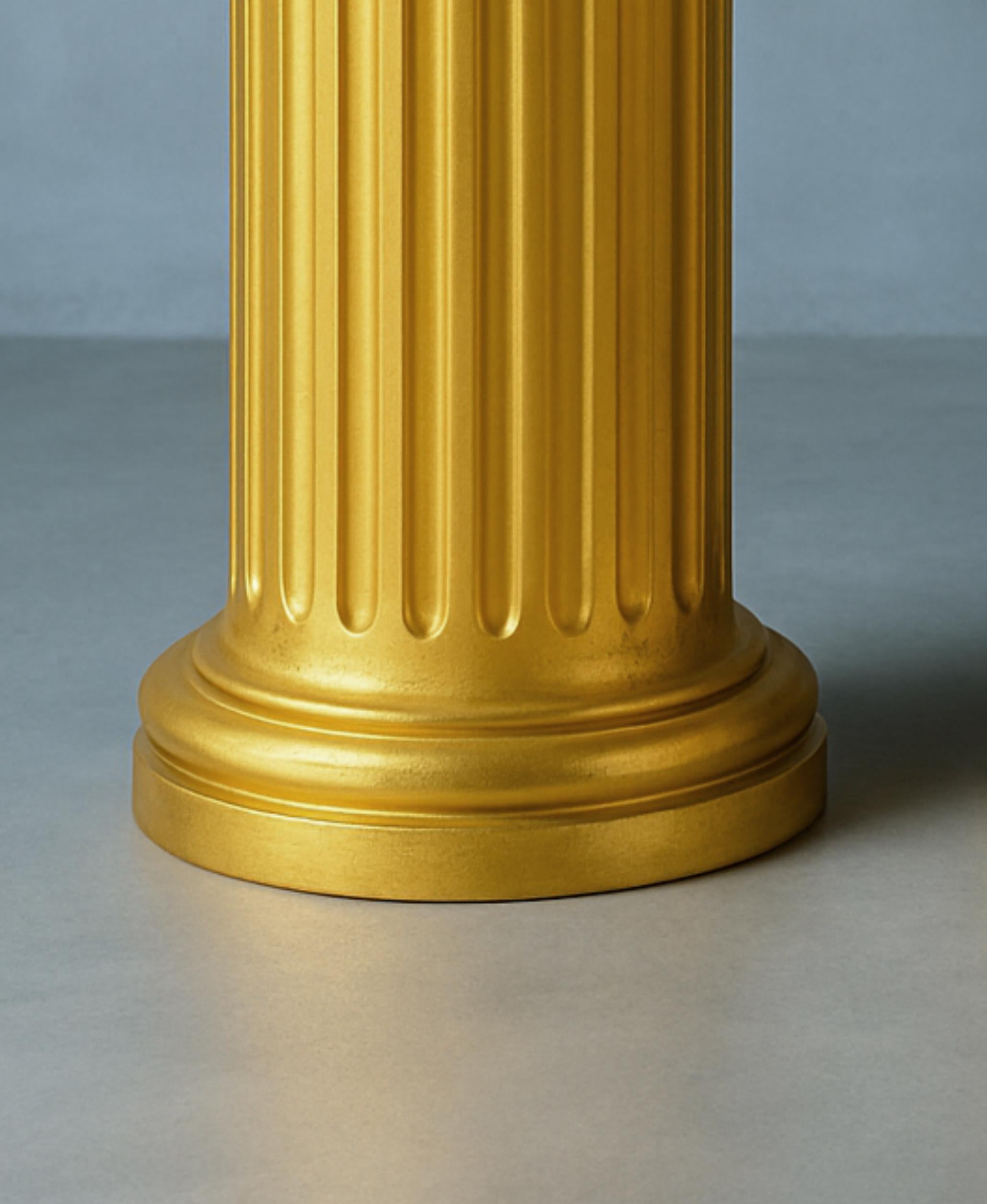 This elegant pair of 19th-century  French gilt golden column showcases the Louis Philippe style. 
The fluted details and horizontal cornice evoke a classic, timeless aesthetic, while the Doric-inspired design adds structural elegance to the