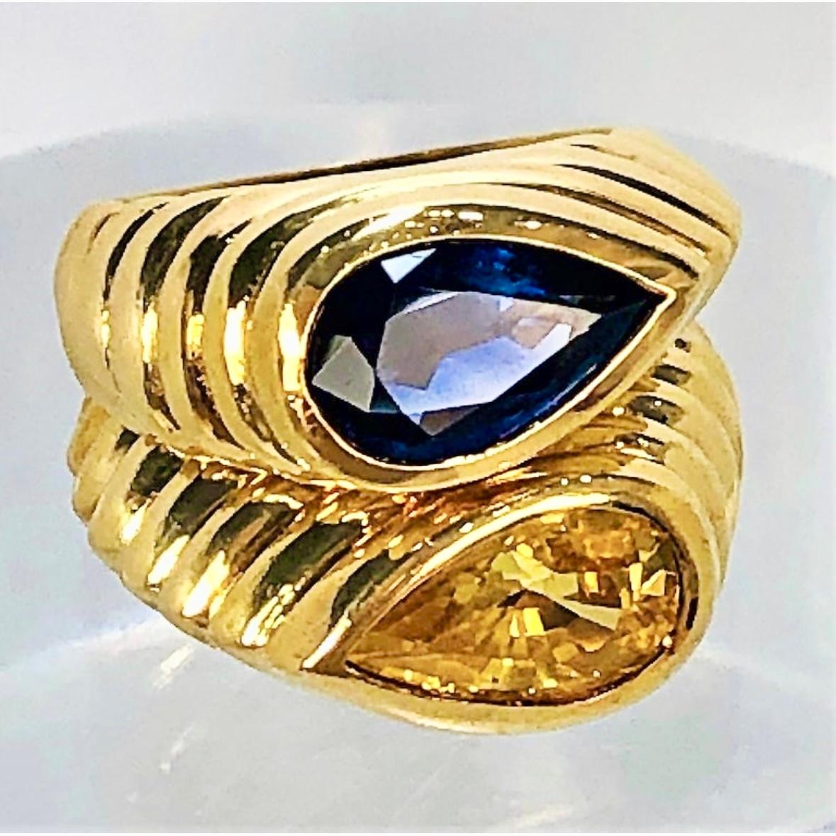 Made of 18K fluted, yellow gold, this heavyweight pair of 
tailored rings by NIVA are bezel set with two faceted pear 
shaped sapphires. The blue sapphire weighs approximately 
2.00CT and the yellow sapphire weighs approximately 2.40CT. 
Both rings