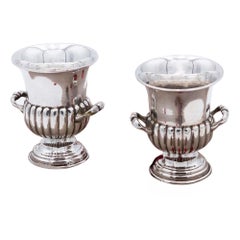 Pair of fluted silver cups with raised handles