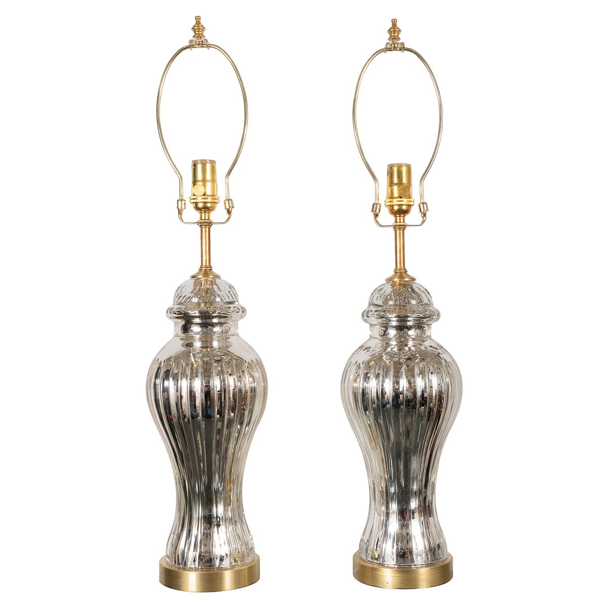 Pair of urn-shaped mercury glass lamps with vertical fluting and brass hardware.