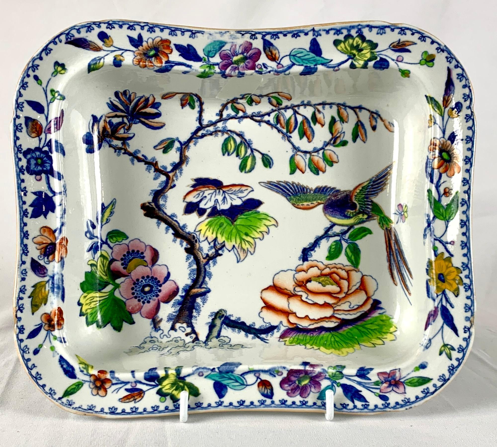This pair of rectangular dishes is decorated in the Flying Bird pattern.
The pattern features a beautiful long-tailed bird flying over a garden and flowers in rainbow colors.
It is painted in a unique combination of purple, pink, yellow, orange,