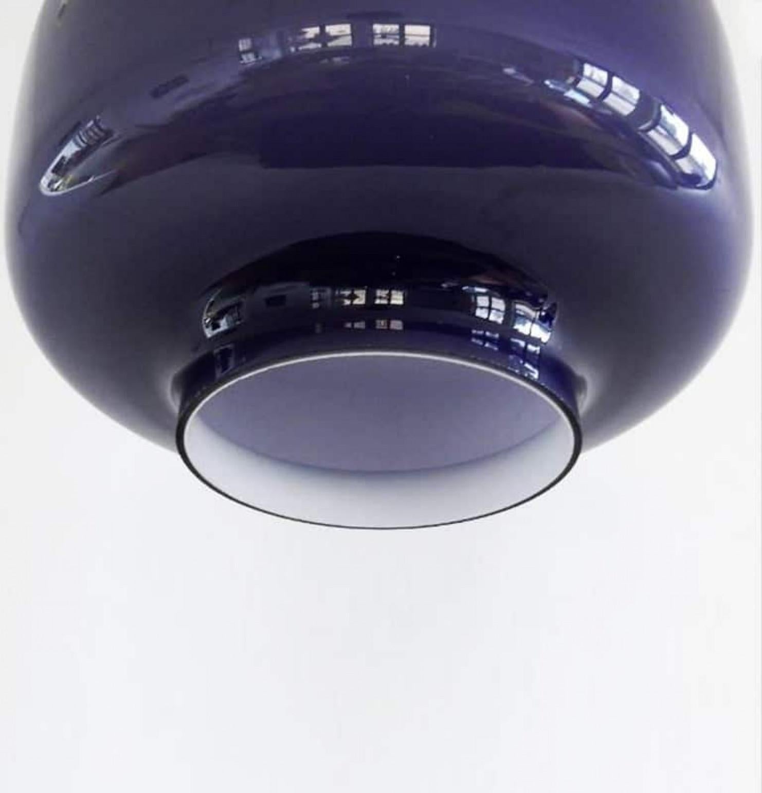 Pair of modernist wall lamps in beautiful warm purple-colored glass. With lovely steel or transparent cable for a clean modern look.
We can deliver different colors of cables and ceiling cups (also purple).

Designed and made in Sweden by Hans-Agne