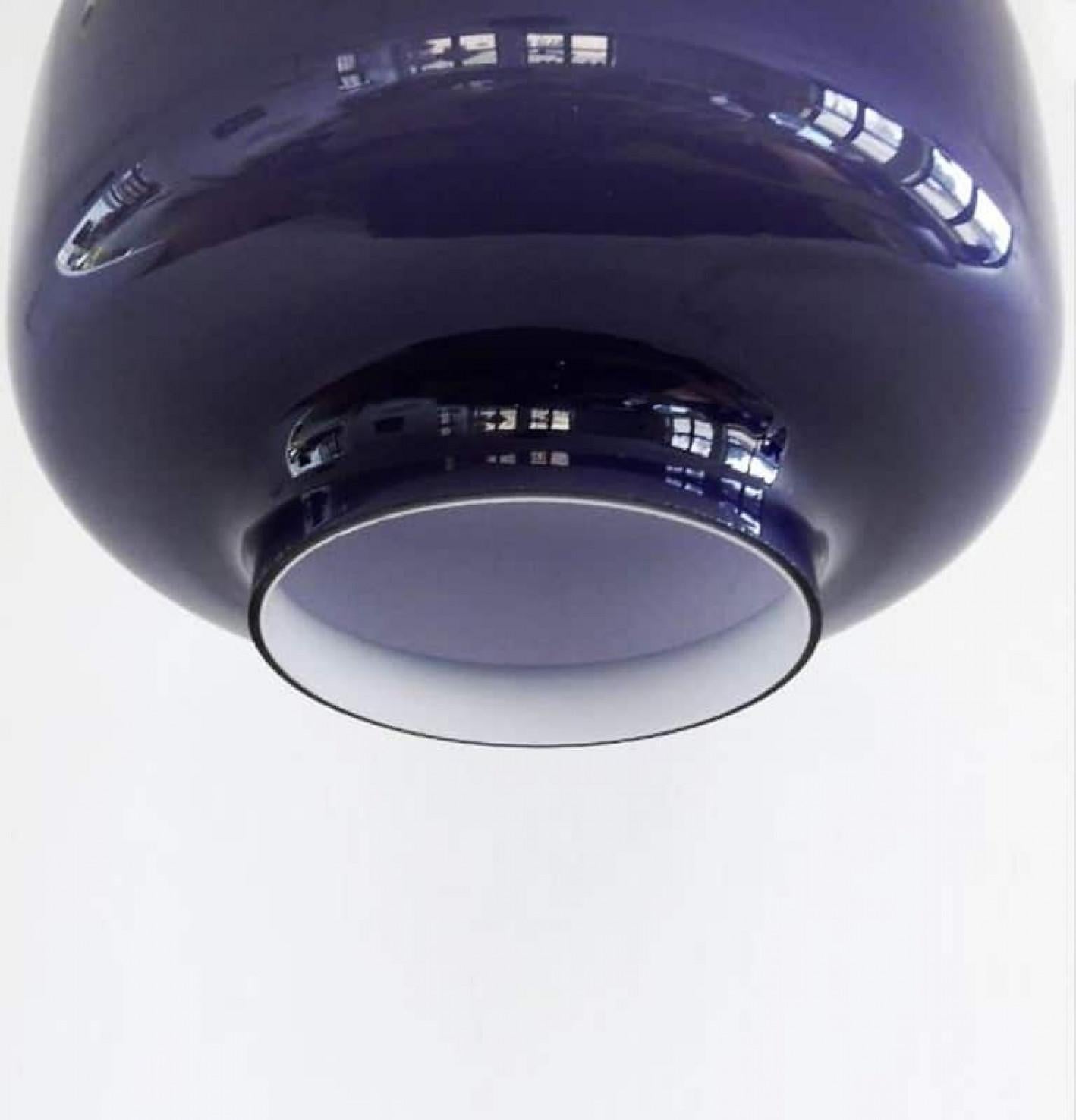 Pair of modernist wall lamps in beautiful warm purple-colored glass. With lovely steel or transparent cable for a clean modern look.
We can deliver different colors of cables and ceiling cups (also purple).

Designed and made in Sweden by Hans-Agne