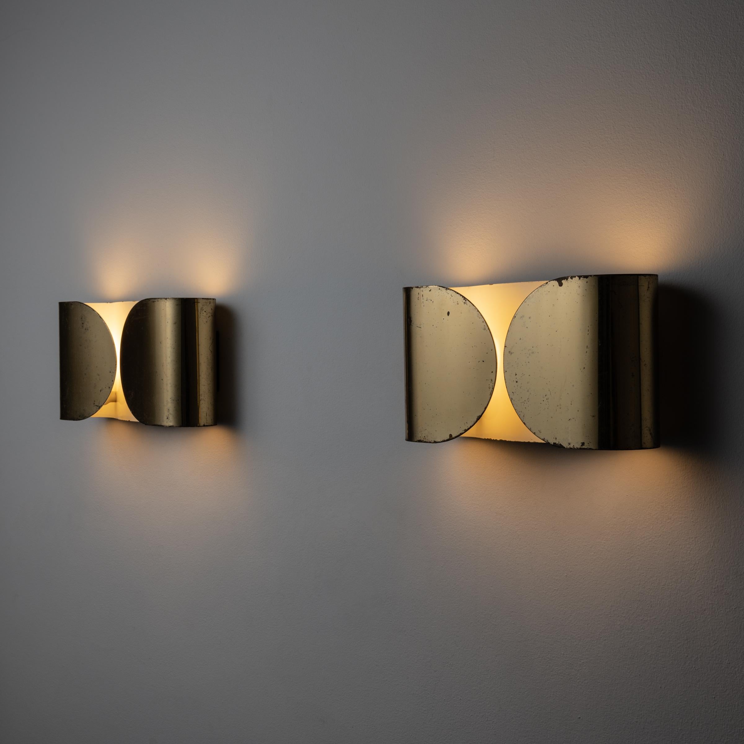 Pair of Foglio sconces by Tobia Scarpa for Flos. Early examples of first production. Designed and manufactured in Italy, 1967. Rewired for U.S. standards. We recommend: two E27 Sockets 75w maximum bulb per fixture. Lightbulbs not included. Priced