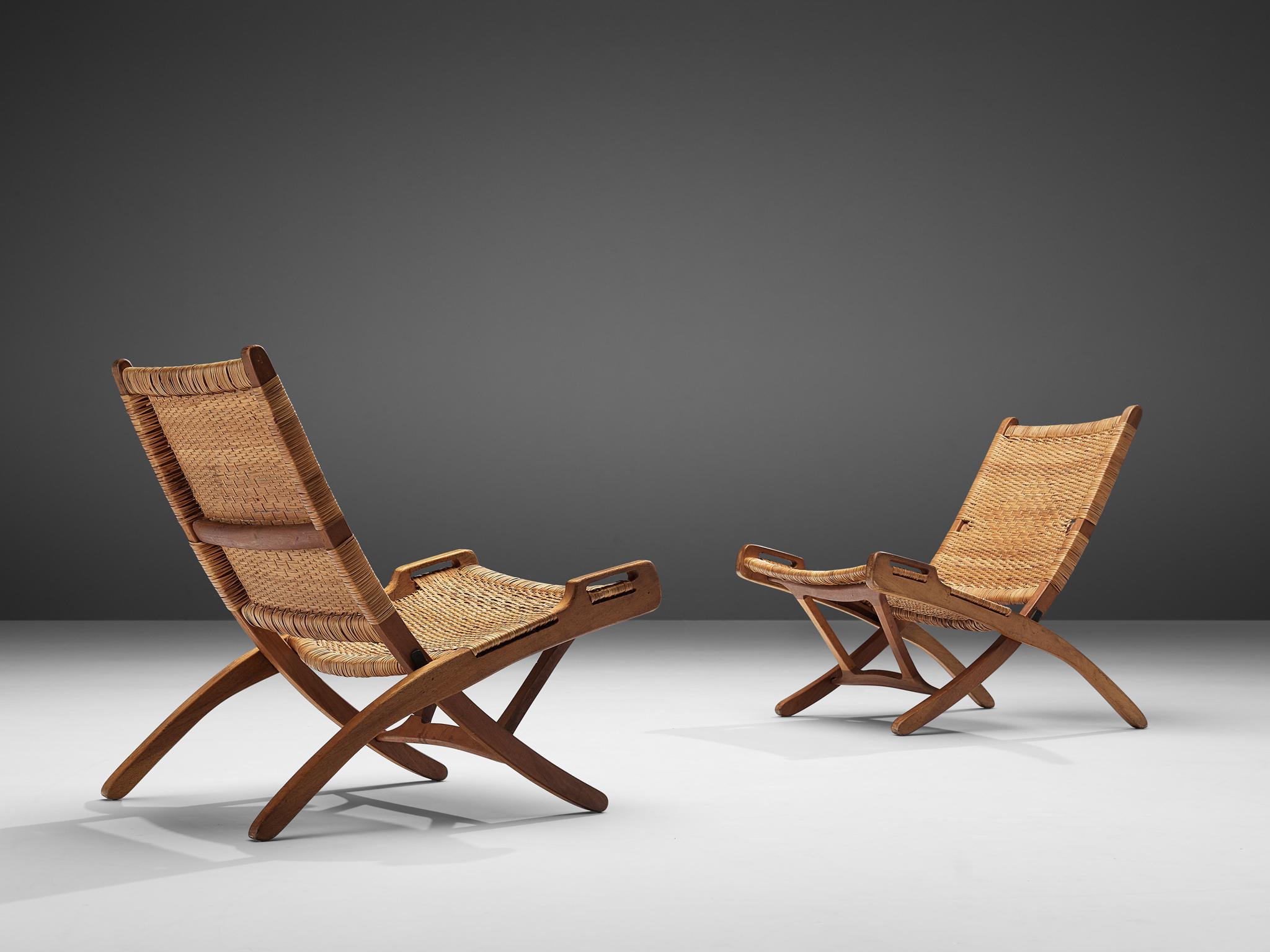 Pair of folding chairs, wicker, teak, Denmark, 1960s.

A foldable and portable chair with a natural appearance. The chair features a beautiful detailed wicker backrest and seating making the low position not only comfortable but also worth seeing