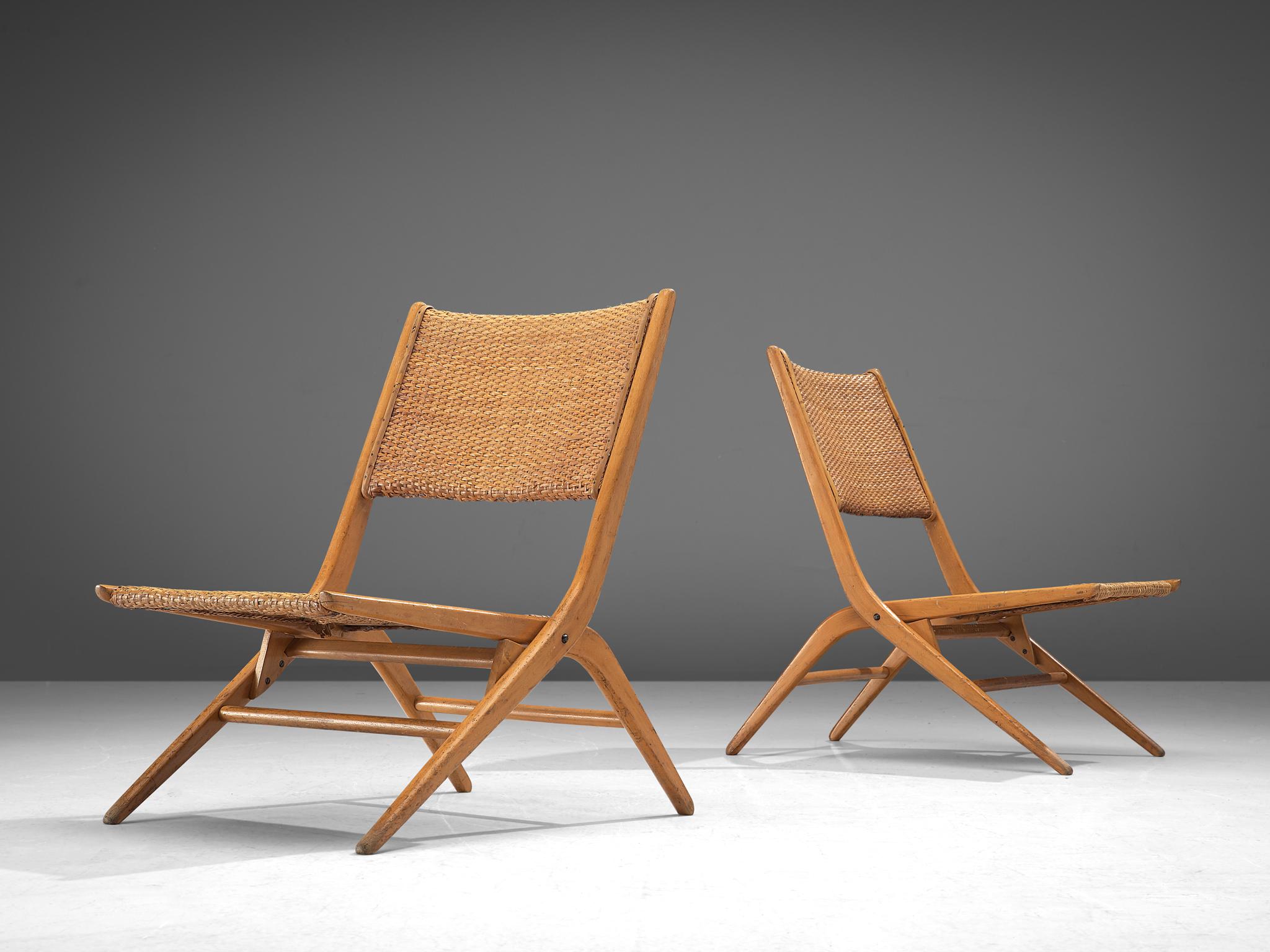 Pair of folding slipper chairs, cane and beech, Italy, 1960s

Elegant French folding chairs made of beech and can. The beech wooden frame is designed with high attention to detail as seen in the openings, curves and lines. Wonderful chairs that
