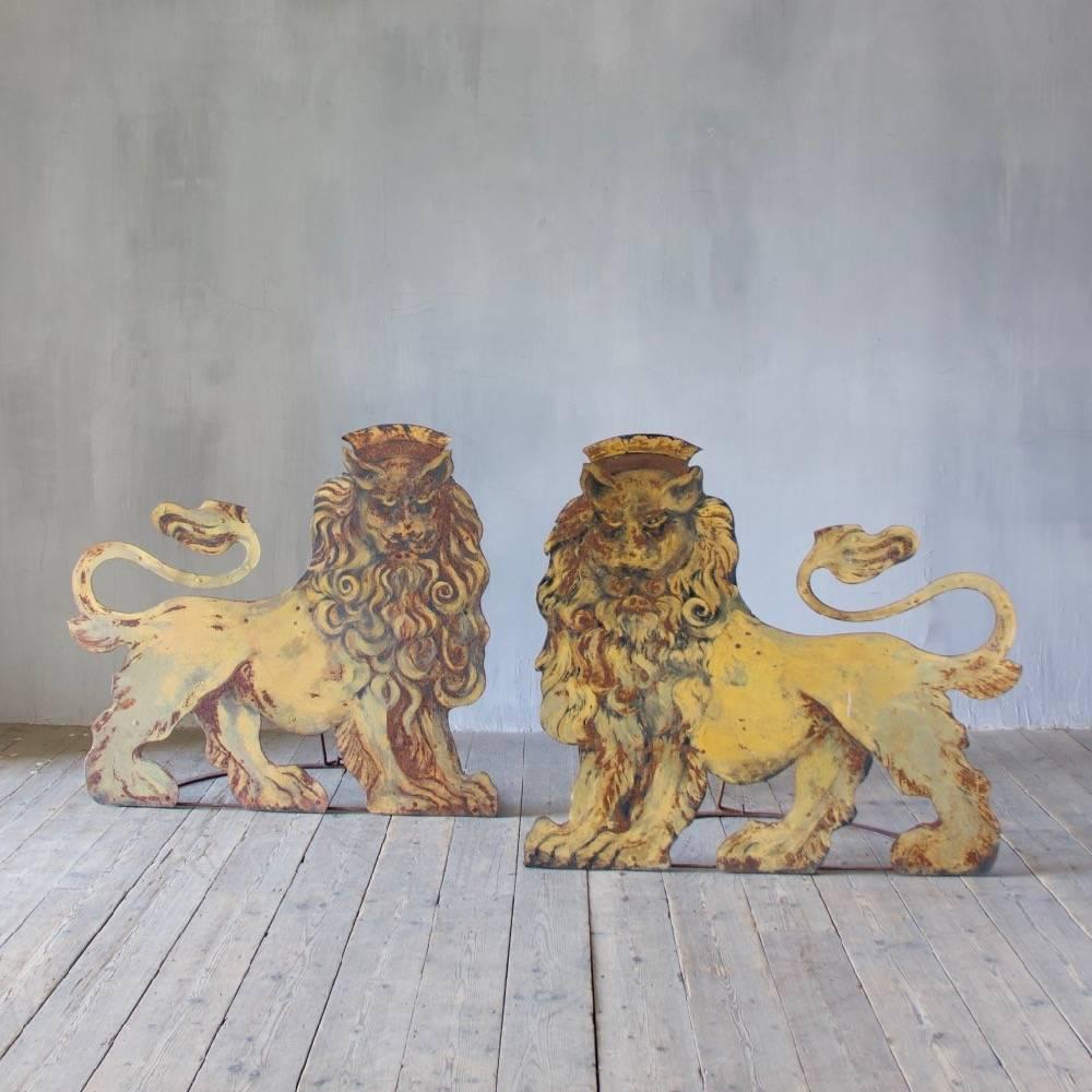 A possibly unique pair of folding wrought iron and tole circus lions, believed to have flanked the entrance to a big top. England, mid-20th century.