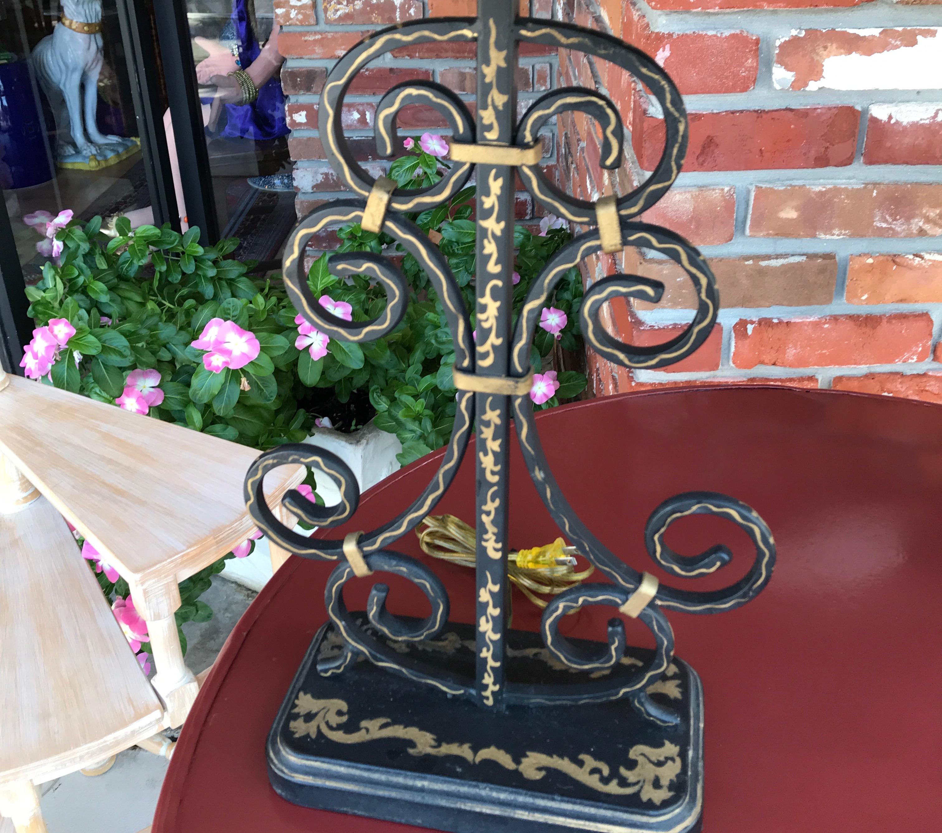 Black and gold wrought iron filigree lamps with hand painted shades.