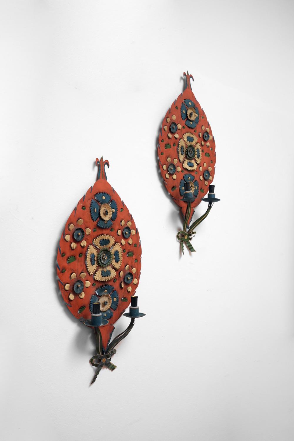 Pair of folk art sheet metal wall sconces painted with blue yellow orange and white. Switzerland, 1950s.