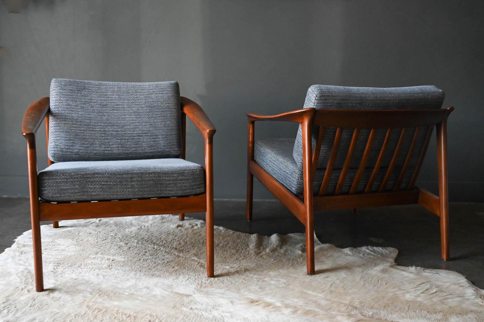 Pair of Folke Ohlsson for Dux Barrel Back Lounge chairs, ca. 1960. Colorado model. Recently professionally restored with newer textured grey chenille tweed fabric and new seat strapping. Excellent condition.