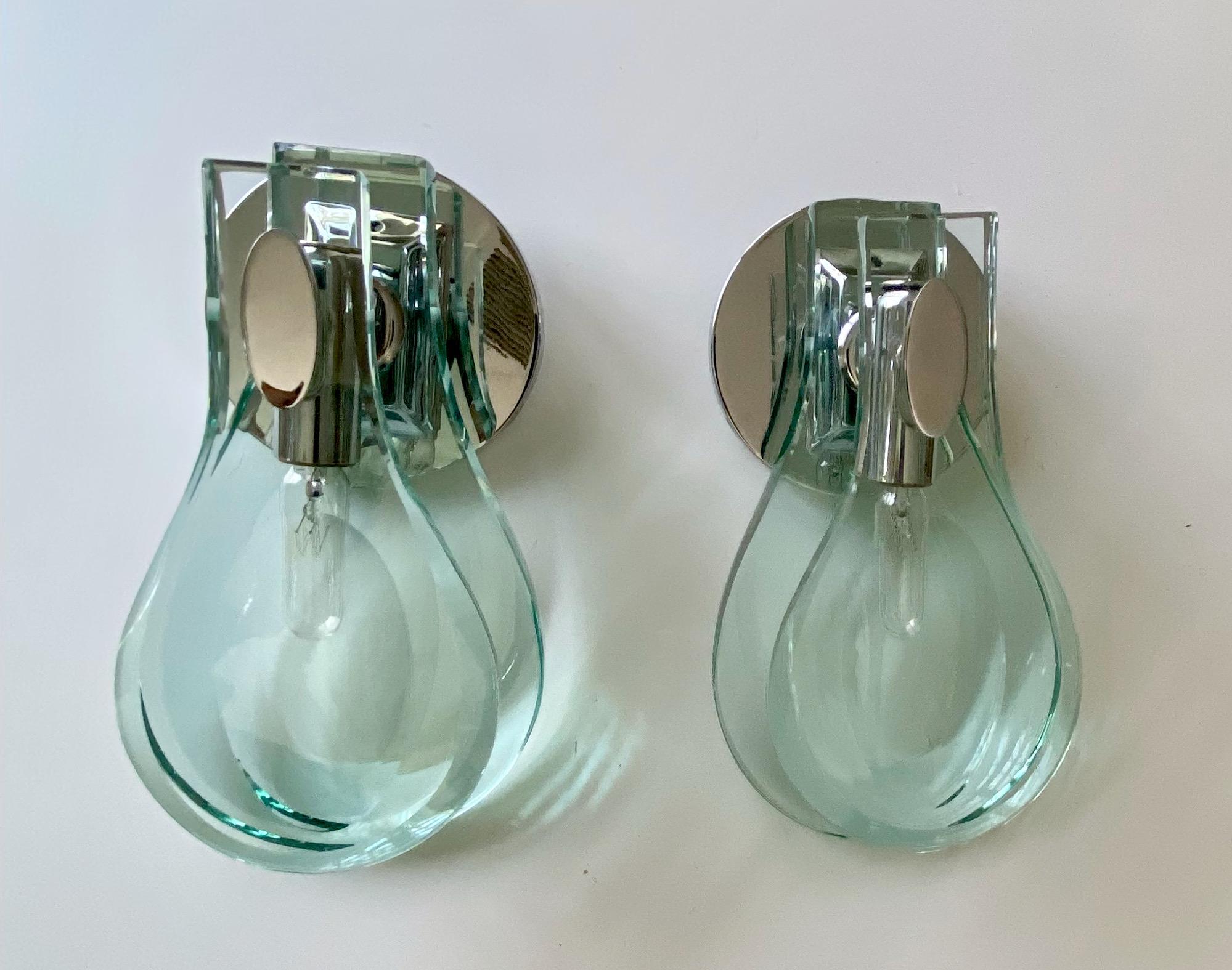 Pair of Italian thick double tear drop shaped wall sconces in the style of Fontana Arte. Their unique design offers upward/downward orientation depending on use and taste. Mounts to 5