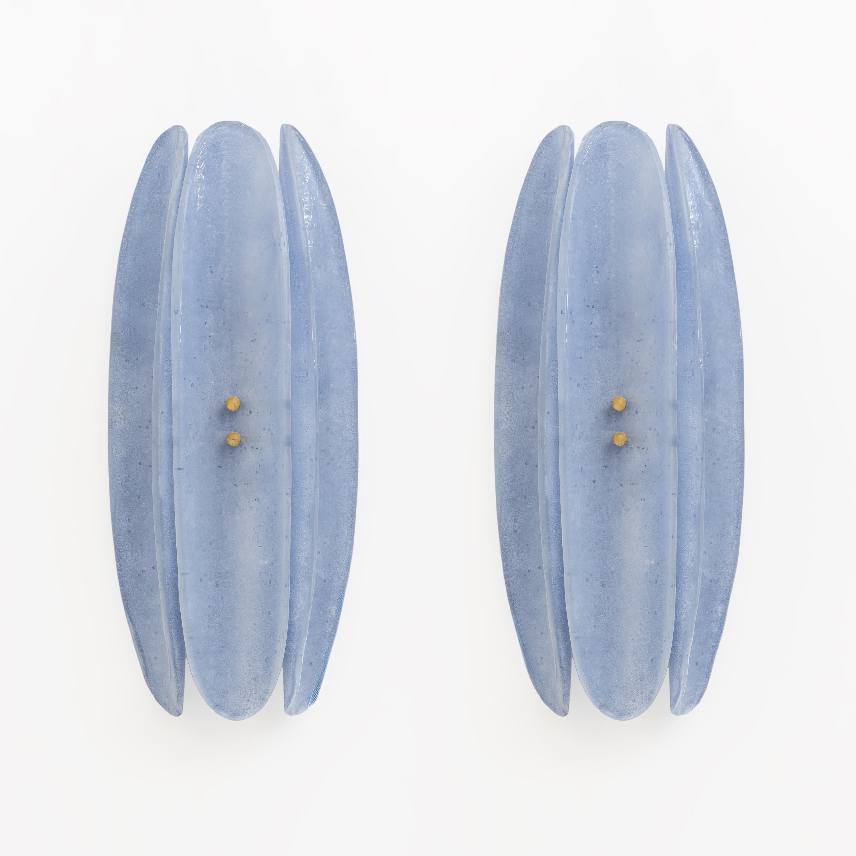 Questa lampada da parete è composta da tre elementi organici, curvi e a forma di foglia in vetro di Murano satinato, nello stile di Fontana Arte. Le parti allungate e concave abbracciano la struttura in ottone in una forma semicircolare, conferendo