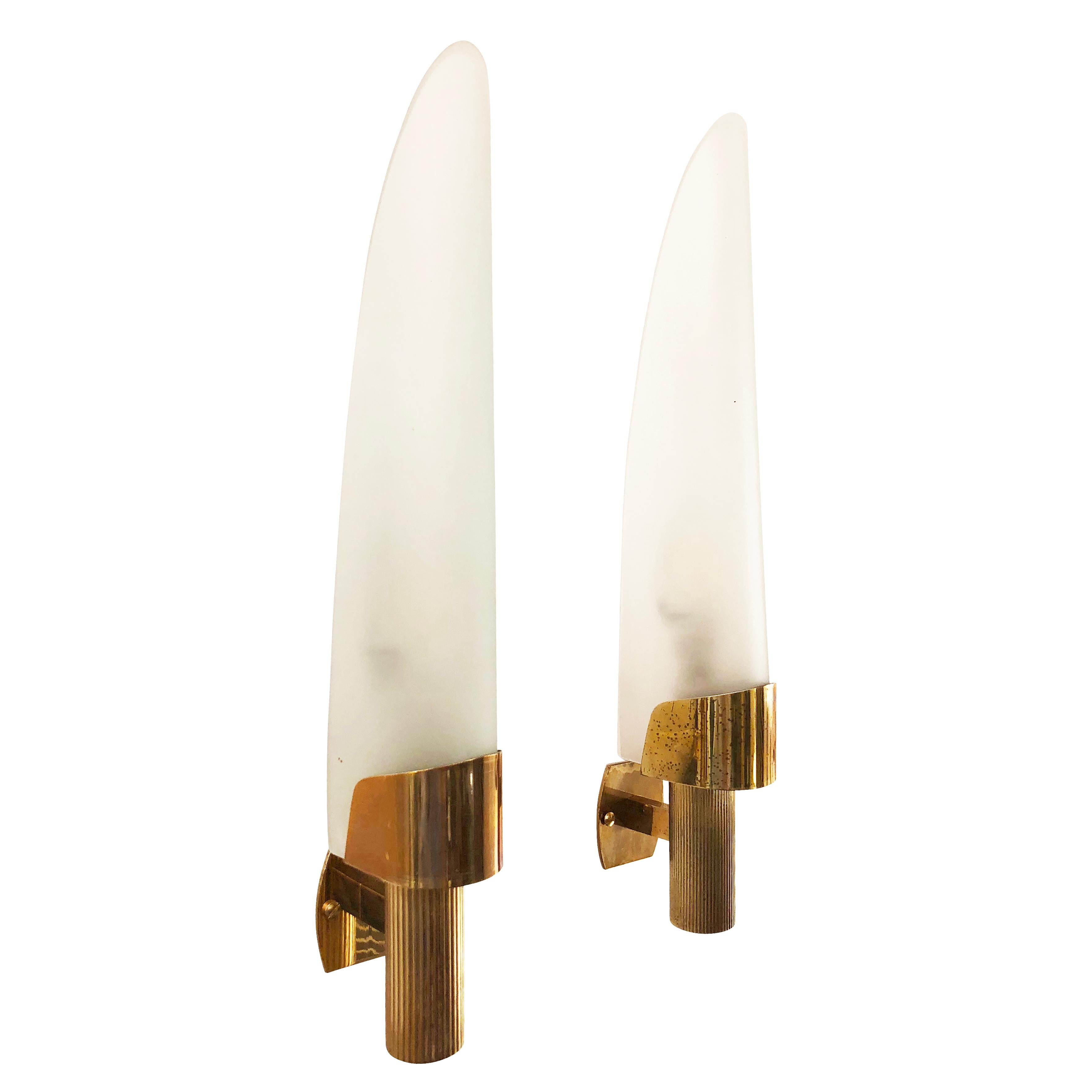 Pair of narrow sconces made by Fontana Arte in the 1960s. Each features a frosted glass on a brass frame. They have been left in original condition for authenticity purposes but can be polished on request at no additional cost. There are slight