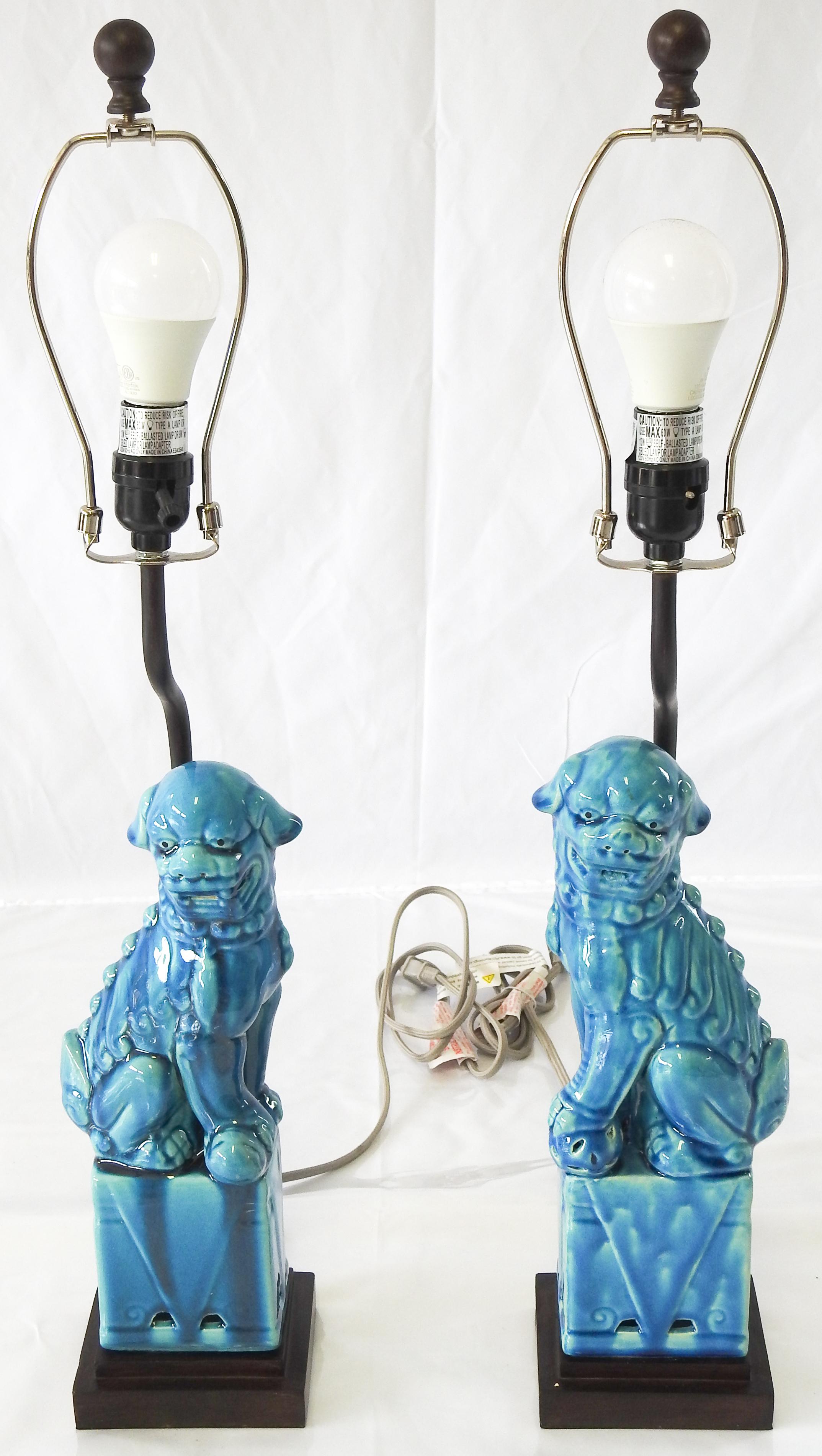 Offering this beautiful pair of turquoise glazed foo dog lamps. Starting on a simple base the dogs sit on. There is a rod behind the dogs that leads up to the socket.