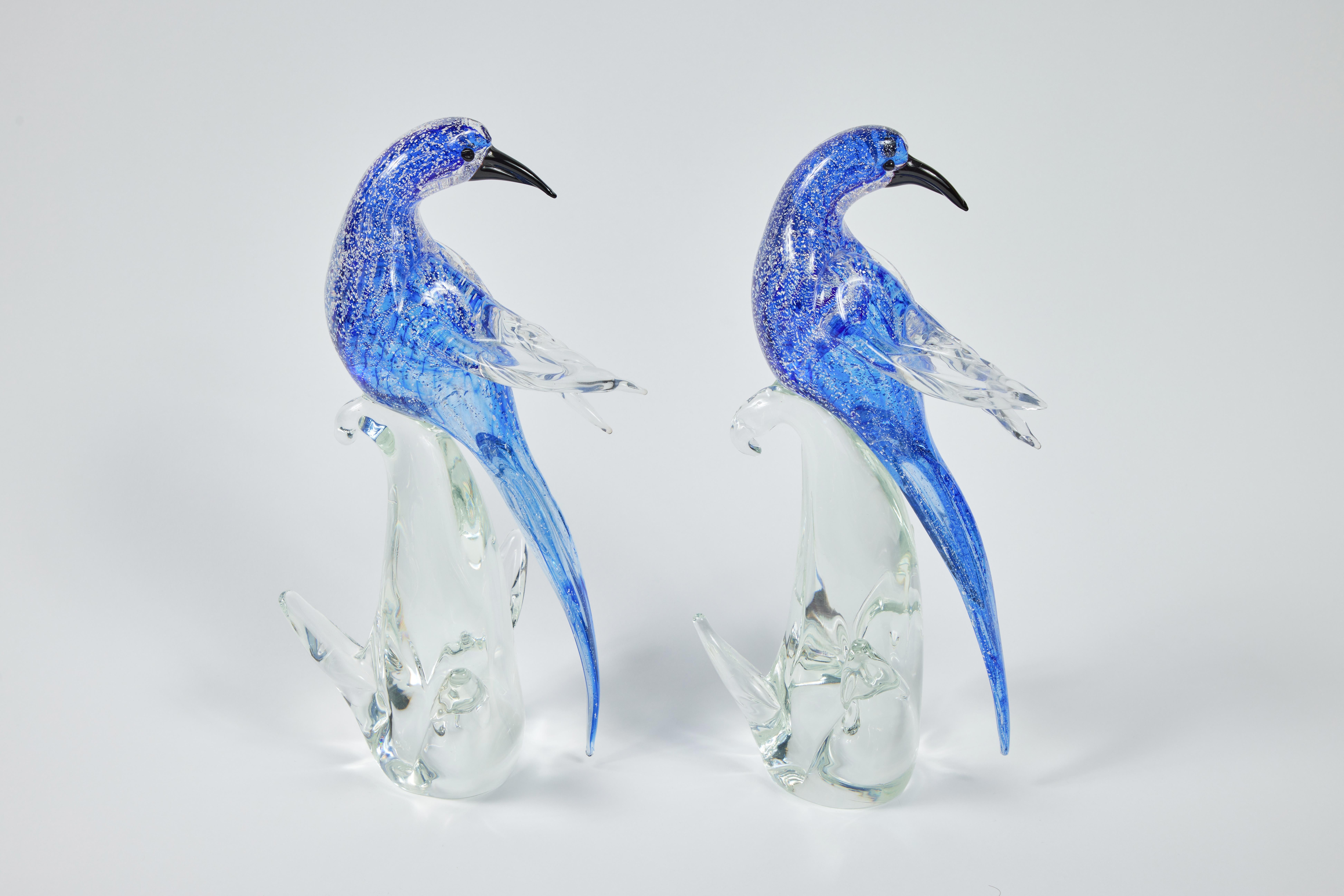 Lovely pair of Formia di Vetri cobalt blue with silver and clear glass Murano birds. Blue silver flecked bodies band to clear wings. Black eyes and beak. Clear plant-form base.